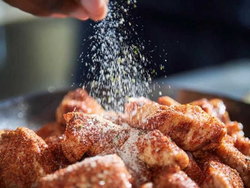 Season the chicken with salt, pepper, and paprika. Mix until evenly coated.