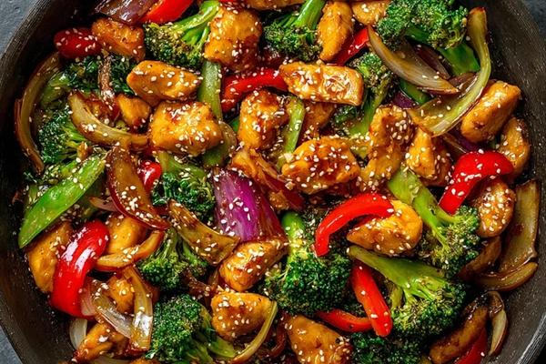 Honey garlic chicken stir-fry with vegetables in a glossy sauce served in a bowl