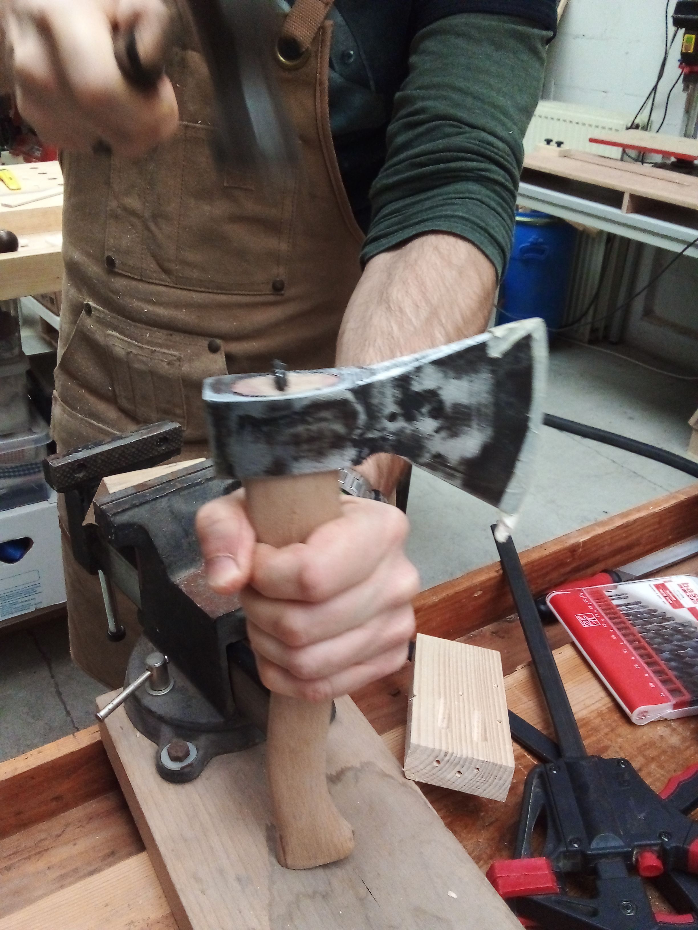 Hammering a nail on an axe