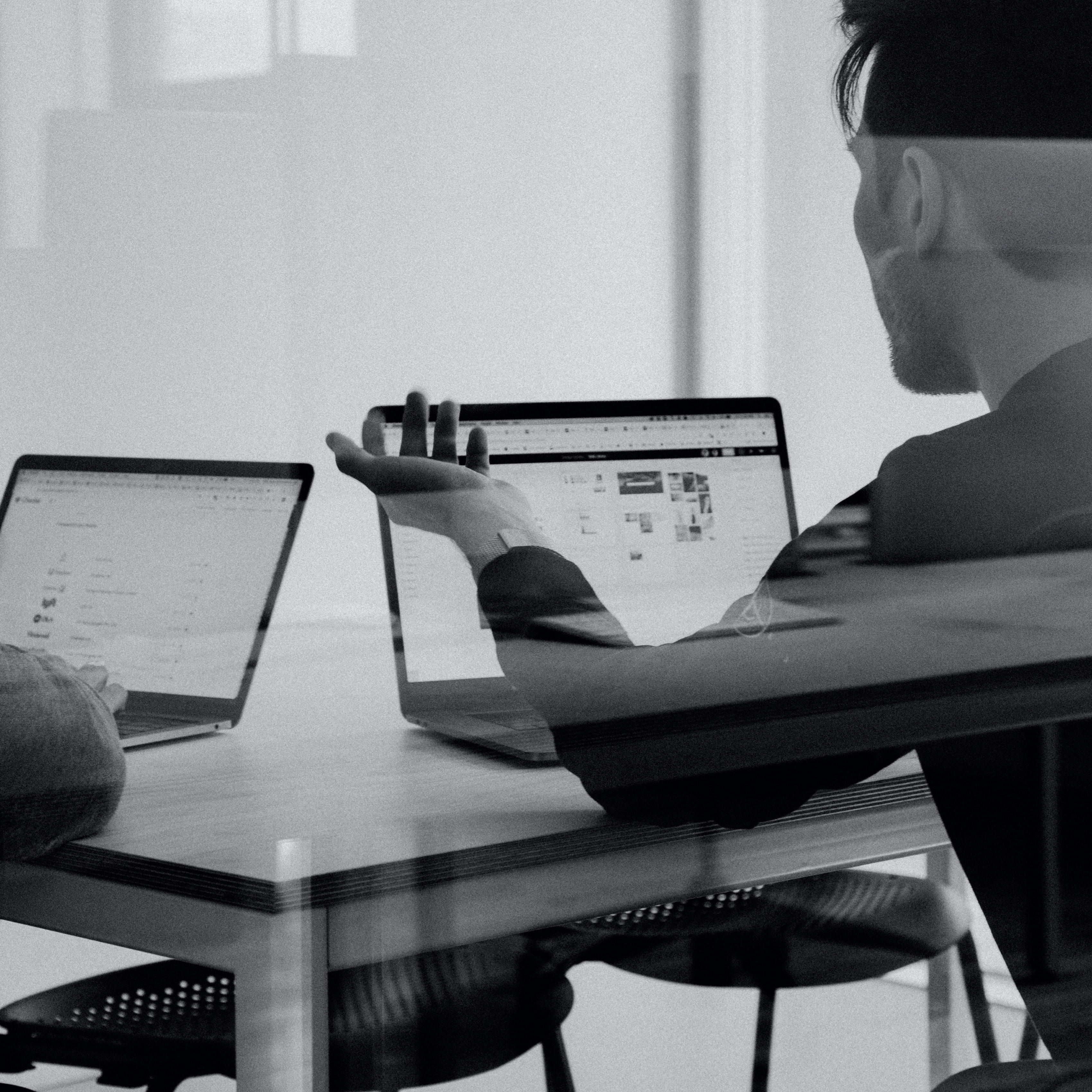 People in meeting with laptops