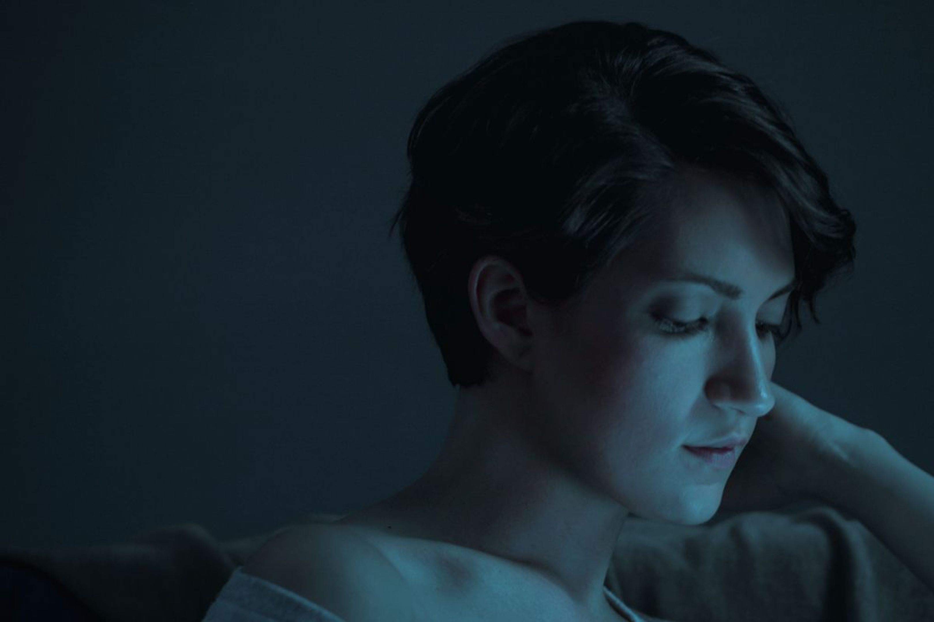 Woman looking at a screen in a dimly lit room