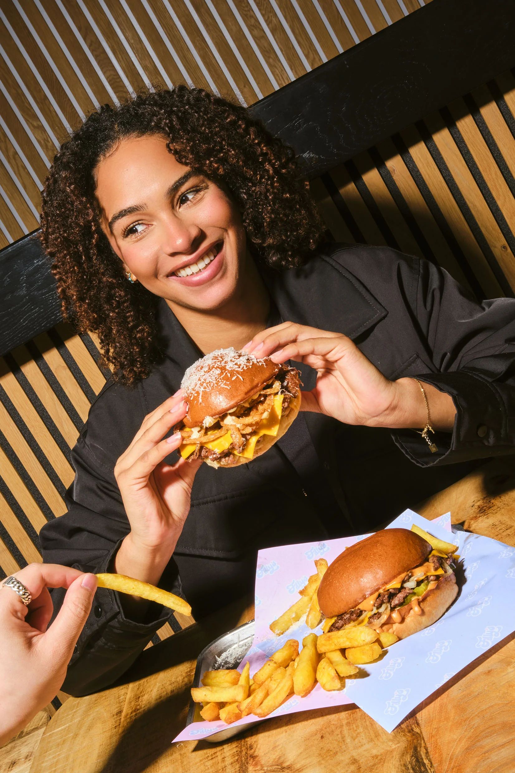 Lachende vrouw met burger en friet