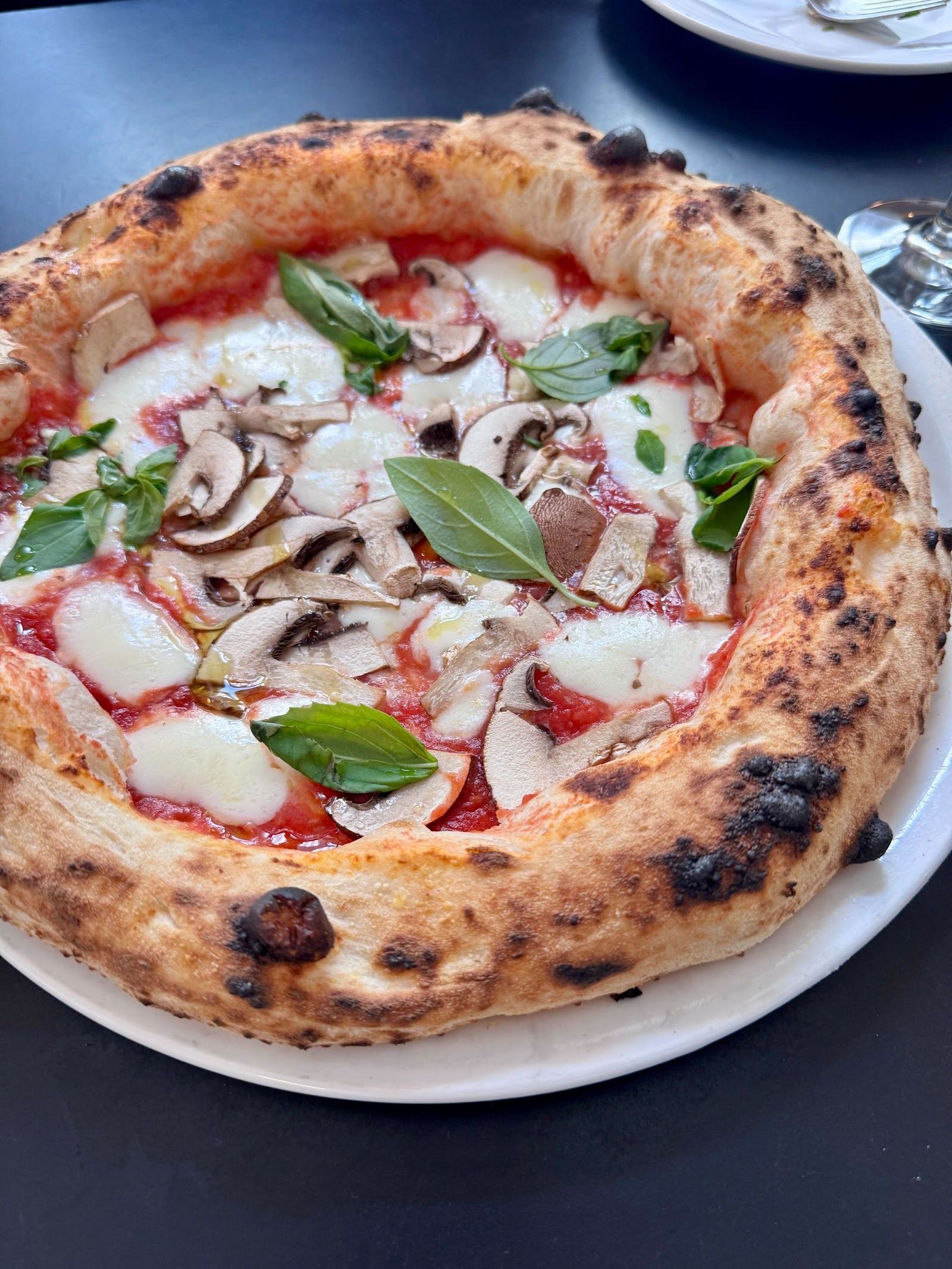 Pizza with mushrooms, mozzarella and basil at Standard Serious Pizza