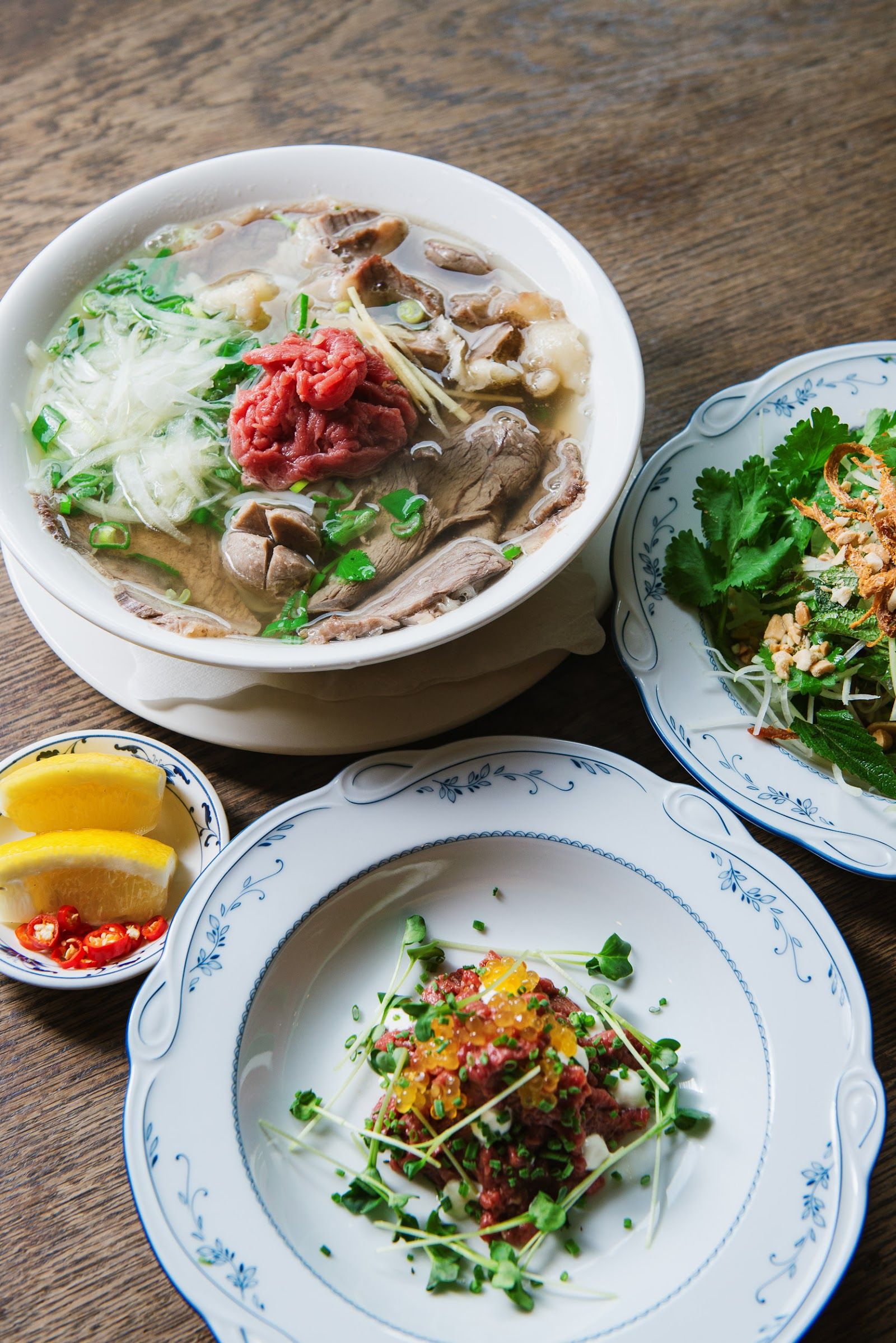Phở with raw beef, herbs and lime on the side at Madame Ngo