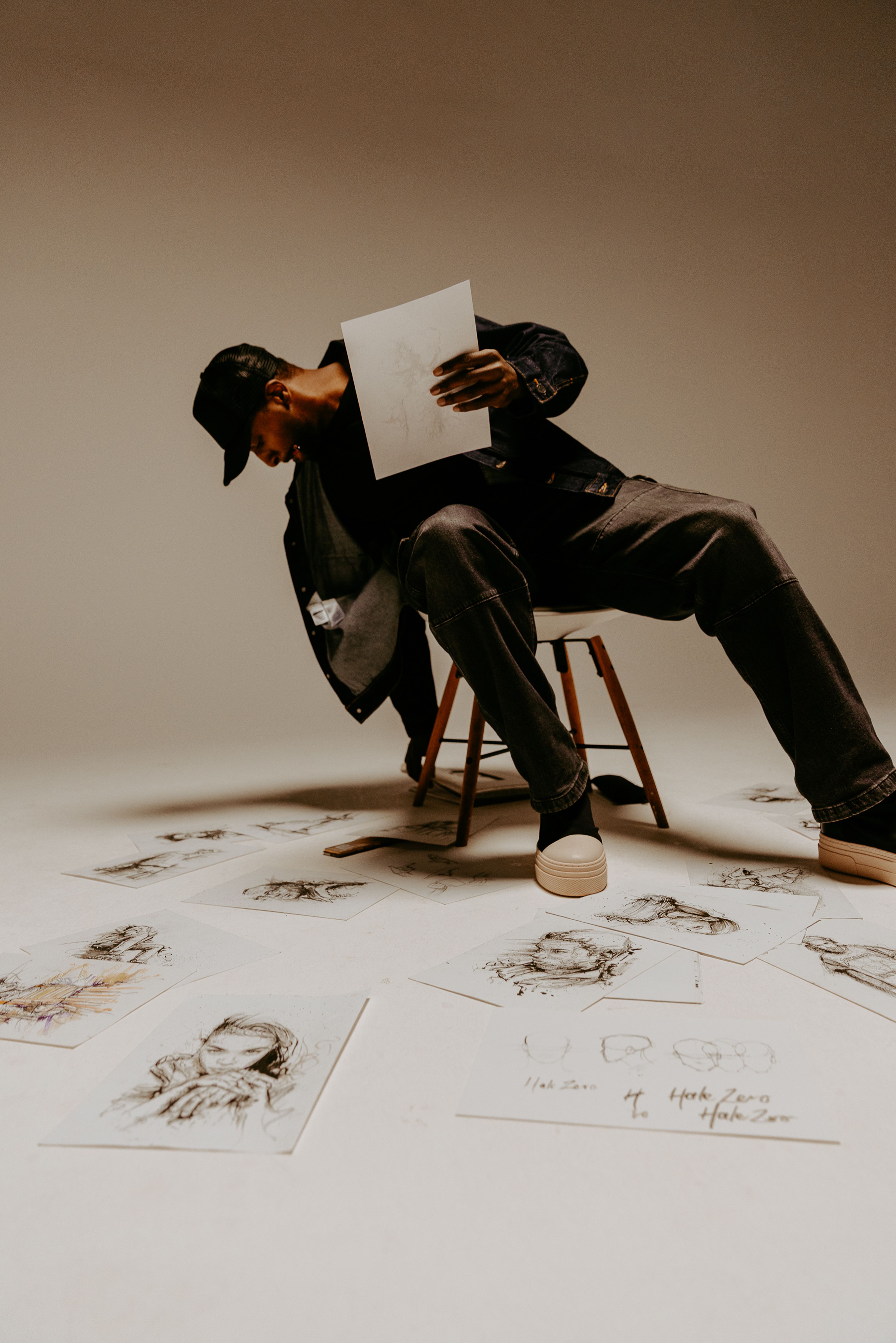 An editorial photo of Carl from Hale Zero surrounded by his artwork.