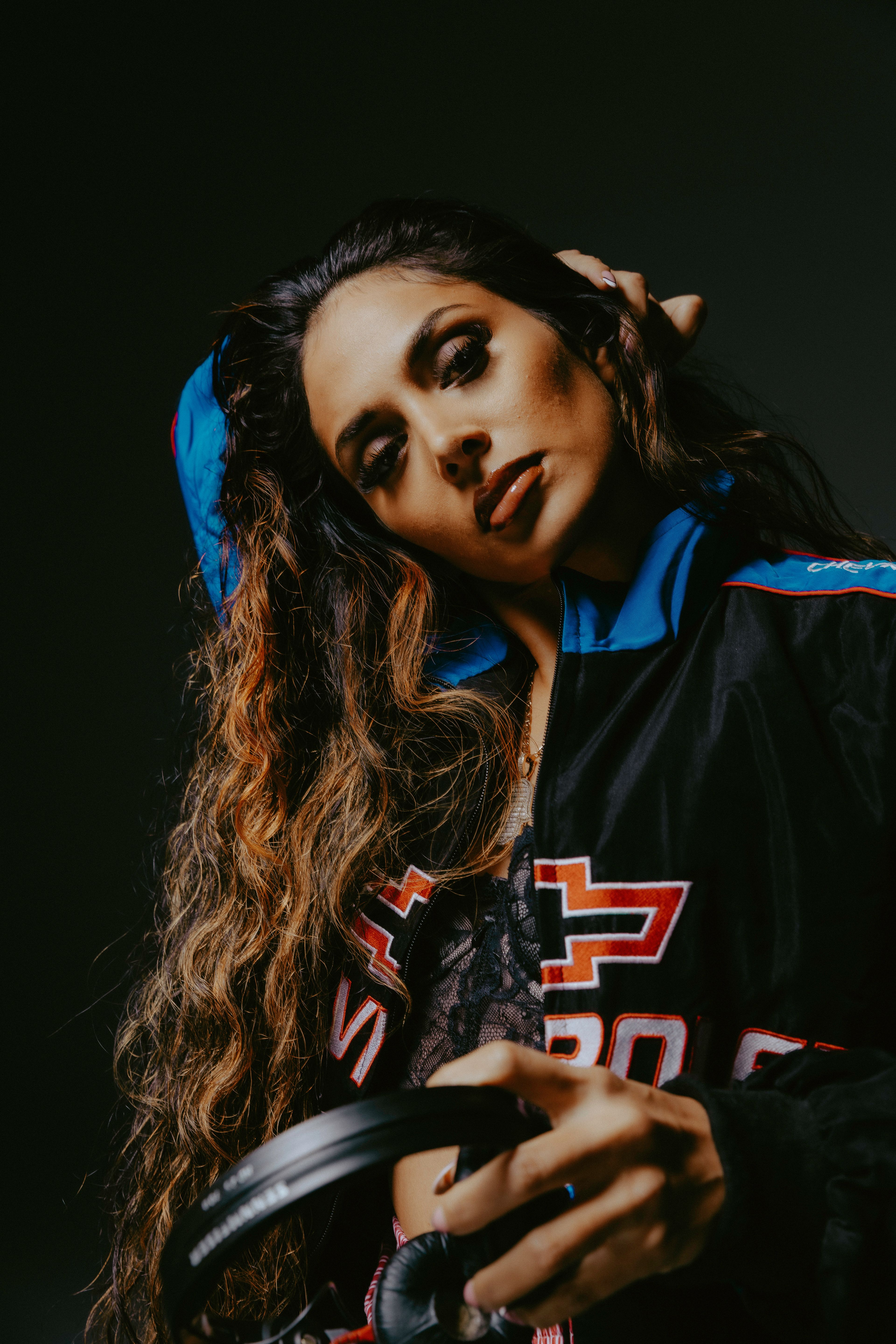 An editorial photo of Soraya holding headphones.