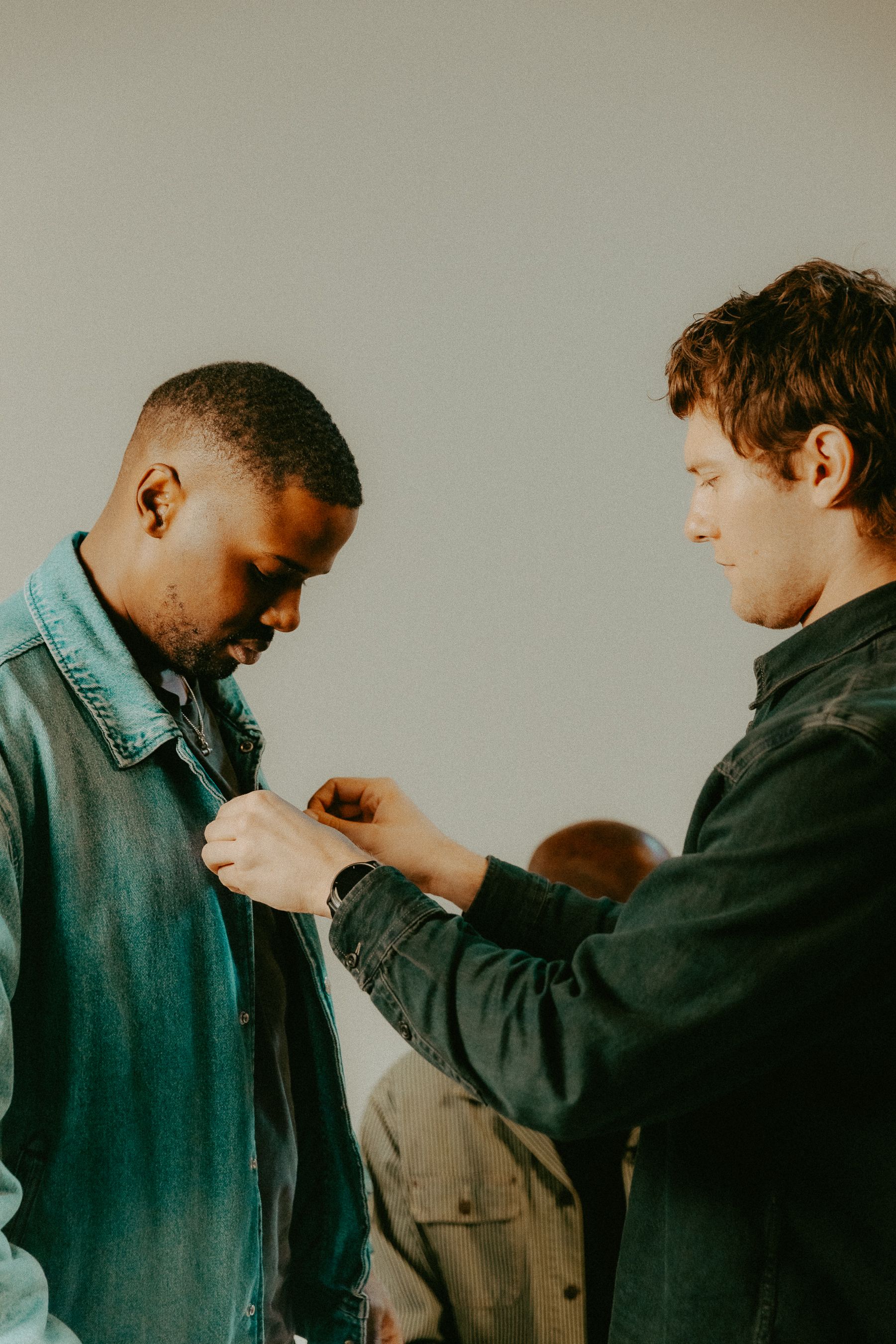 A photo of Oli mic'ing up Hale Zero on a shoot.