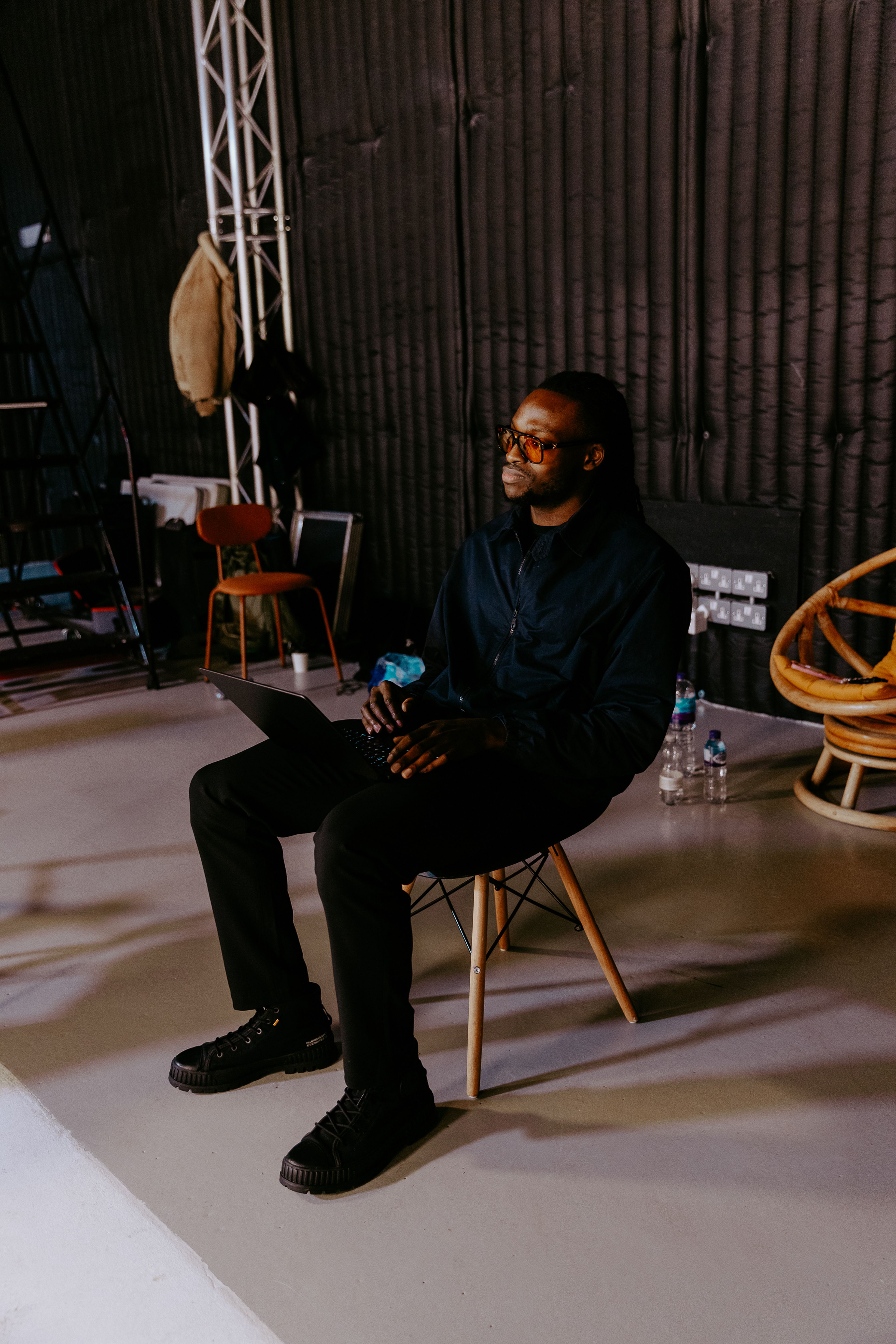 A photo of Dafs sitting on a chair producing on set for Hale Zero.