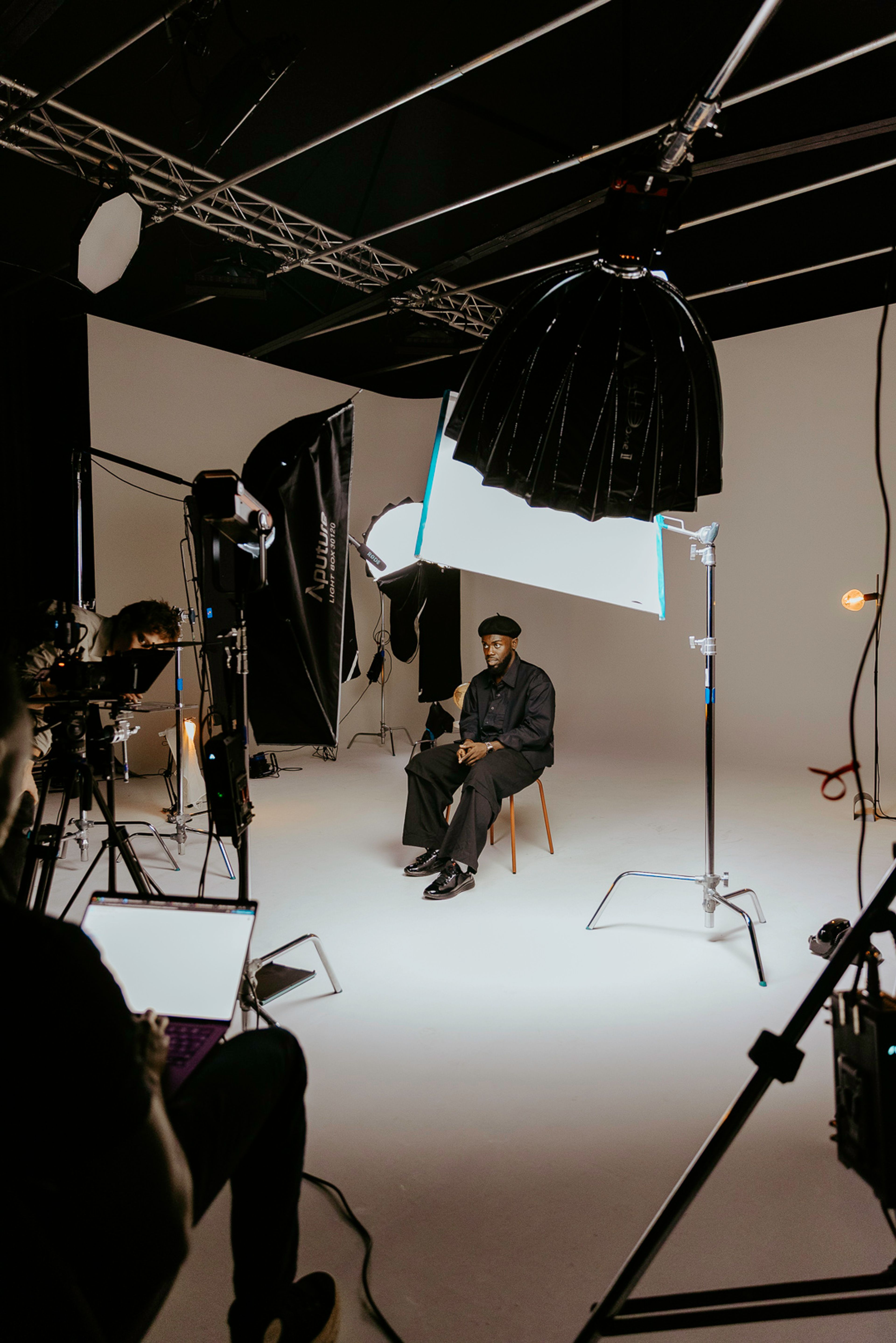 A behind-the-scenes photo of Jeremiah Asiamah and filming equipment on a shoot. 