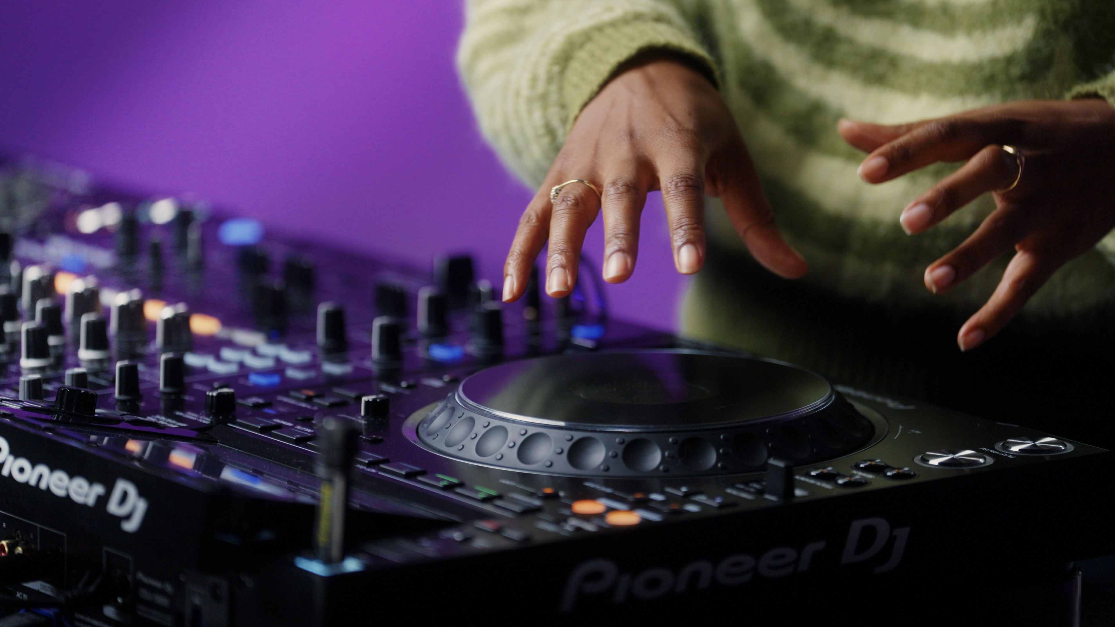A photo of Jamz Supernova's hands over DJ decks.
