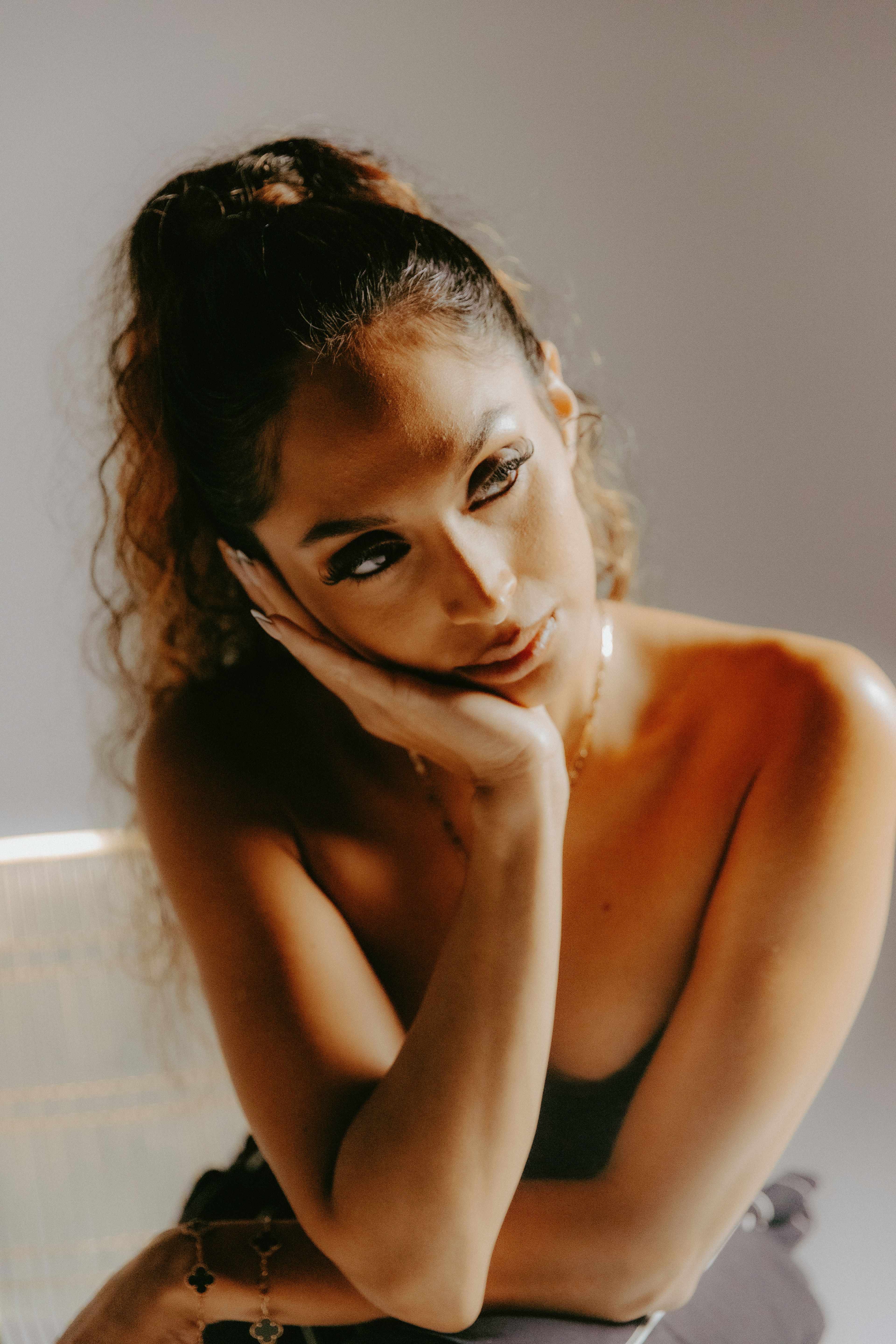 An editorial photo of Soraya sitting on a chair.