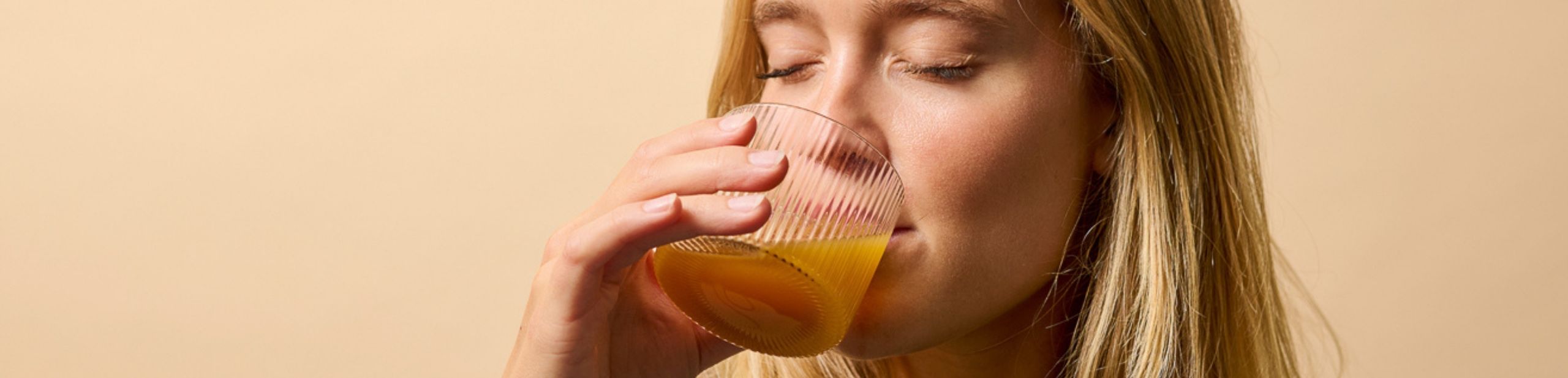 Woman pours cup of tea.