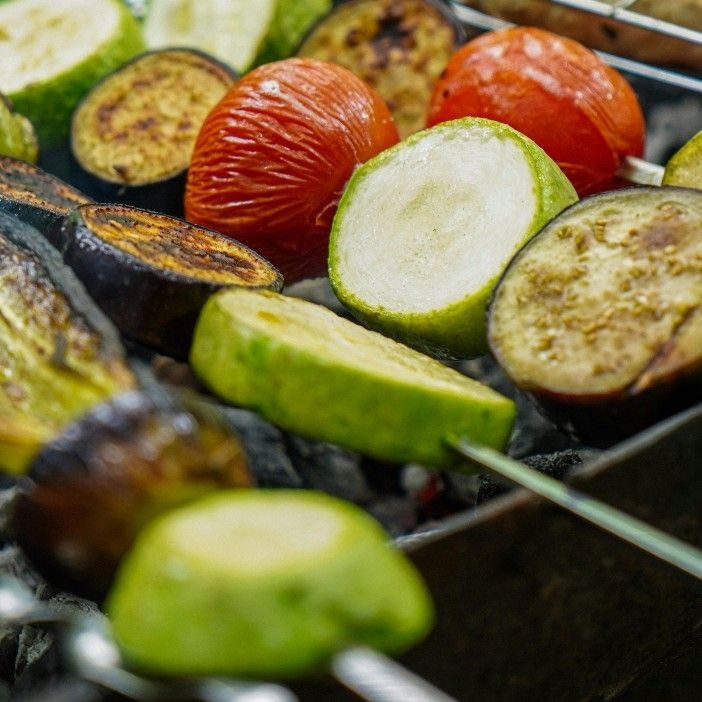 Colorful vegetable skewers on a grill.