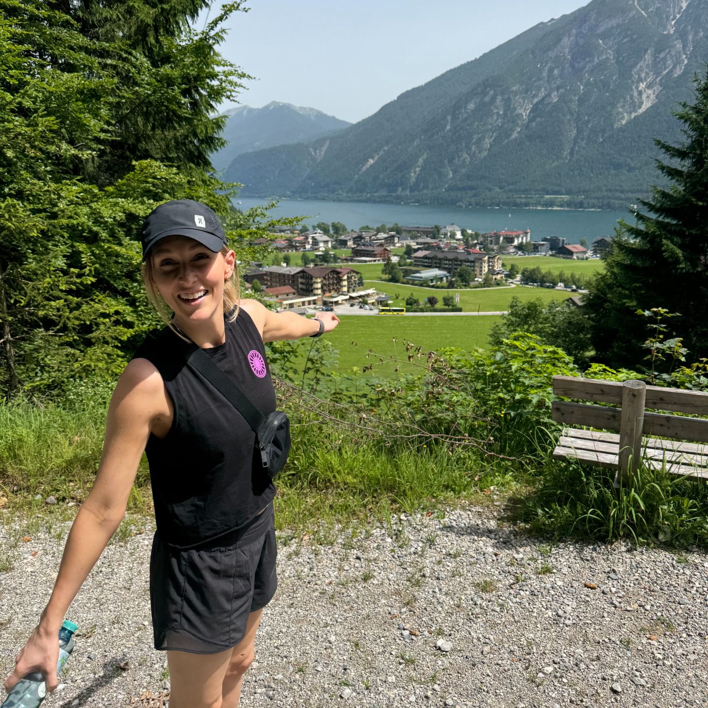 Rachel in front of a mountain and lake panorama.