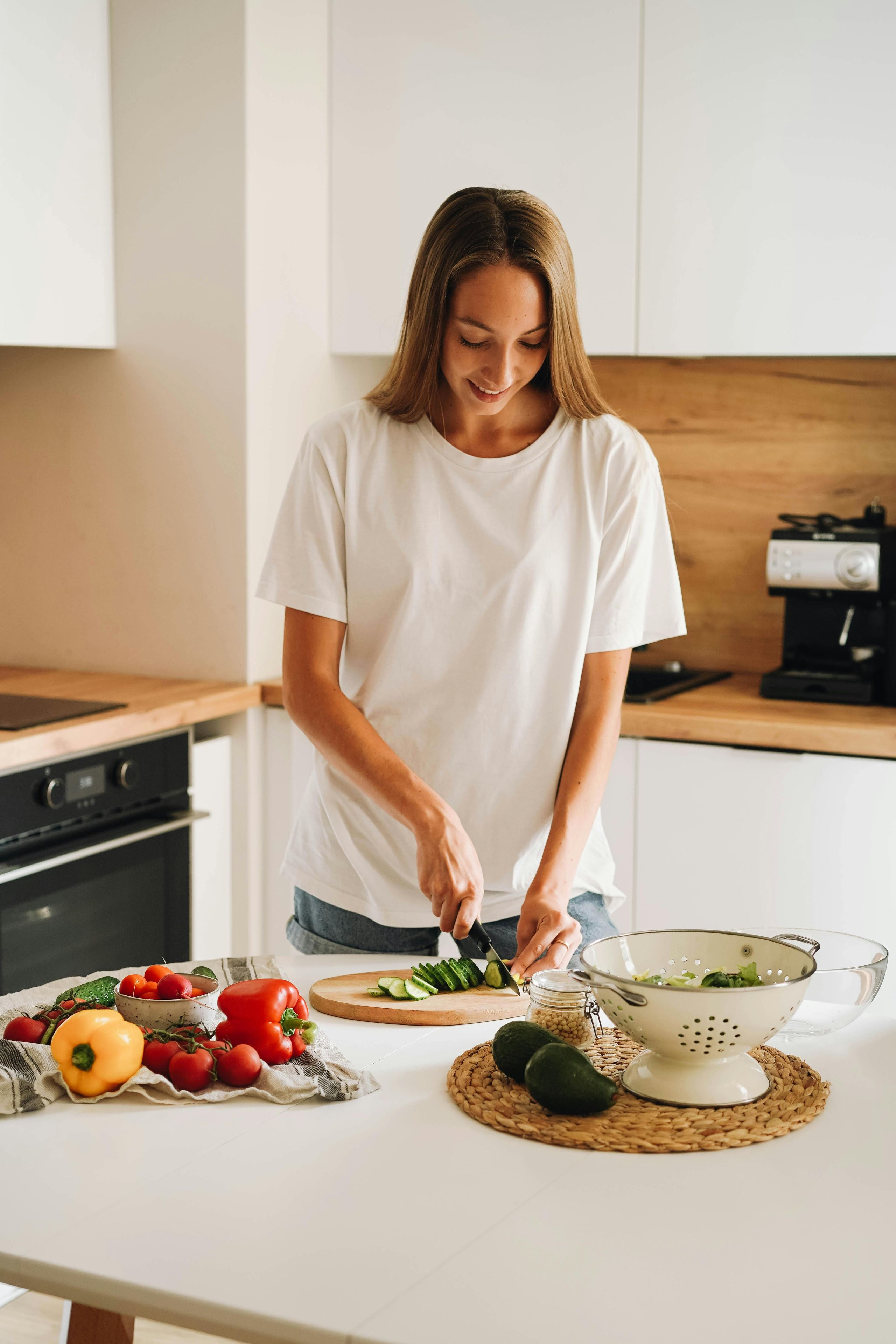 Woman cutting vegetables in her kitchen.