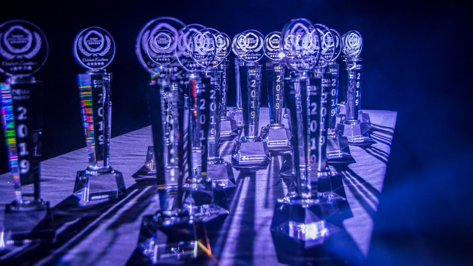 Rows of crystal trophies lit in blue before the ceremony