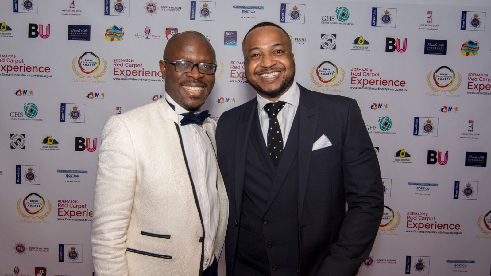 Two guests in dinner suits on the red carpet