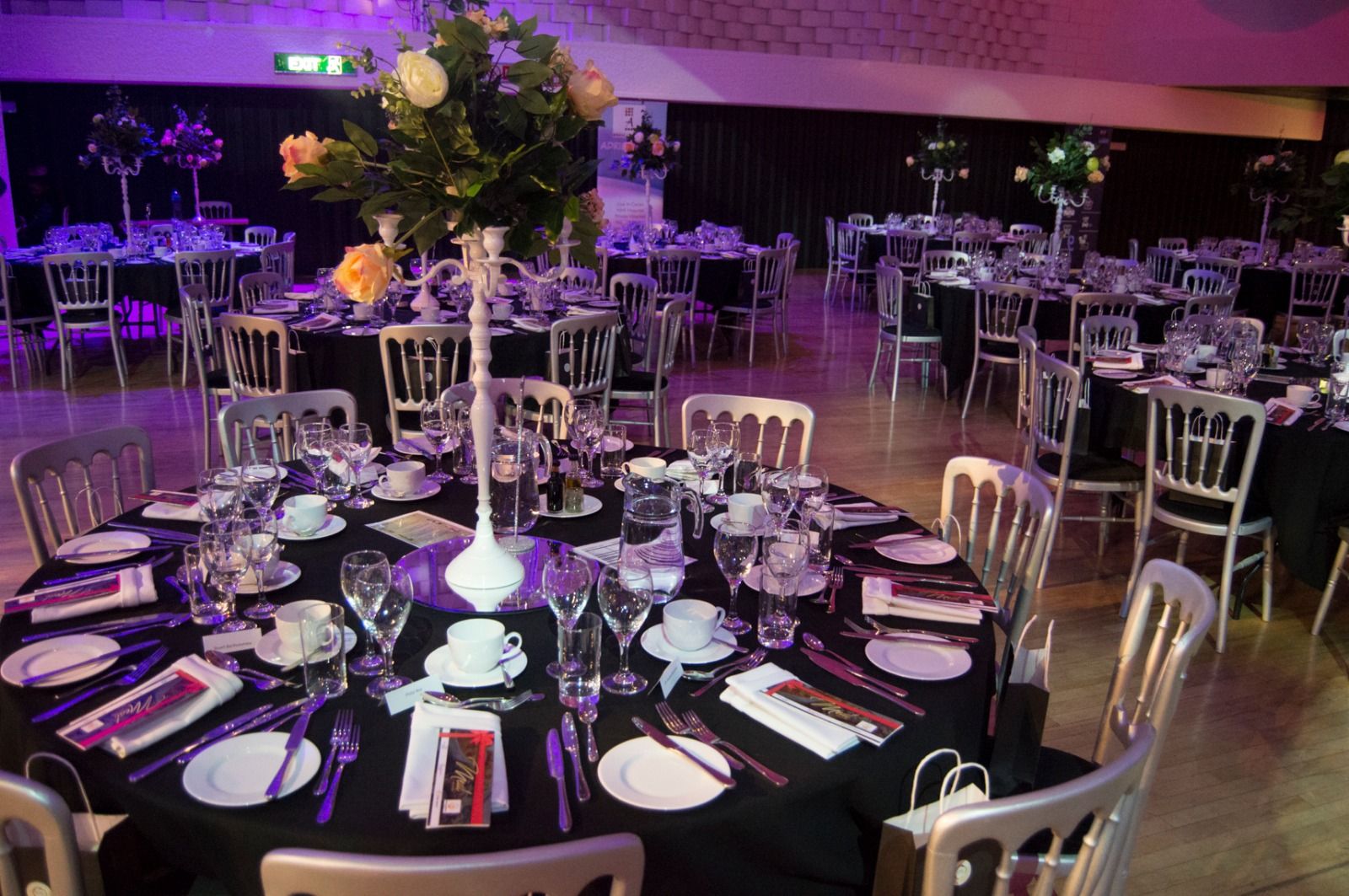 A dinner table set with flowers and candles
