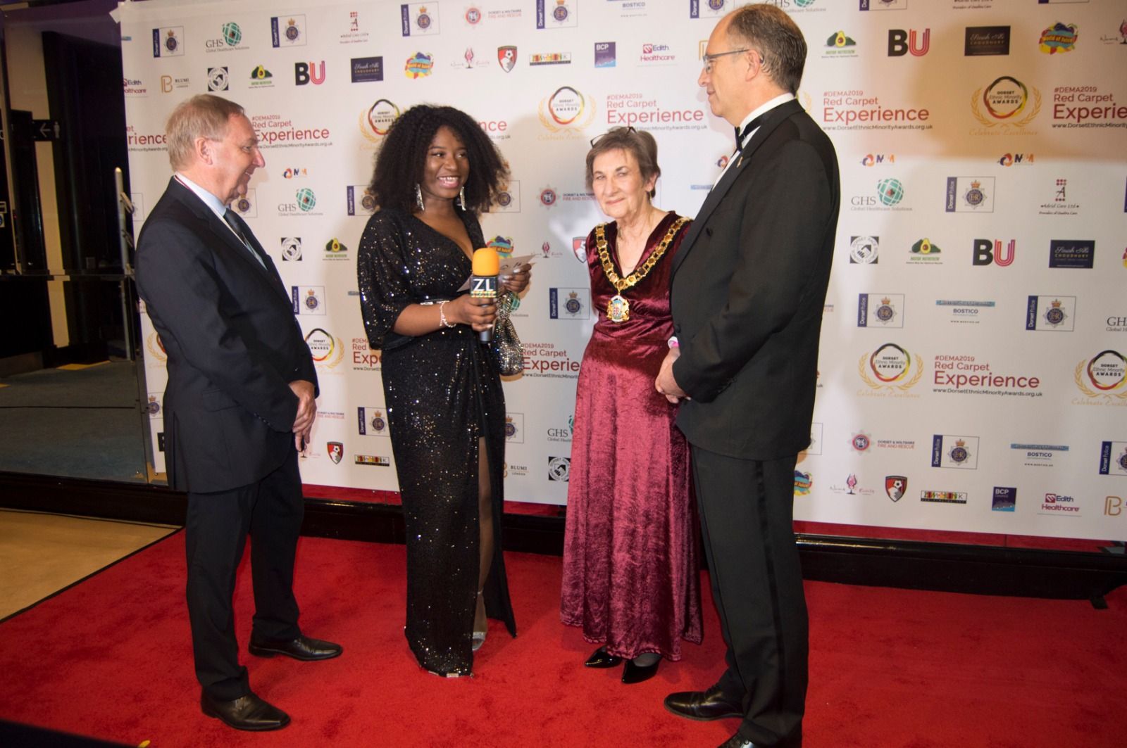 Civic guests with a mayor in her chain of office on the red carpet