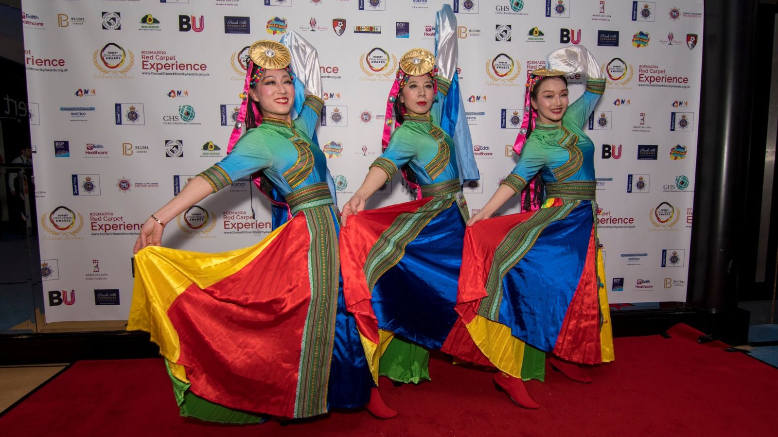 Dancers in bright traditional costumes on the red carpet