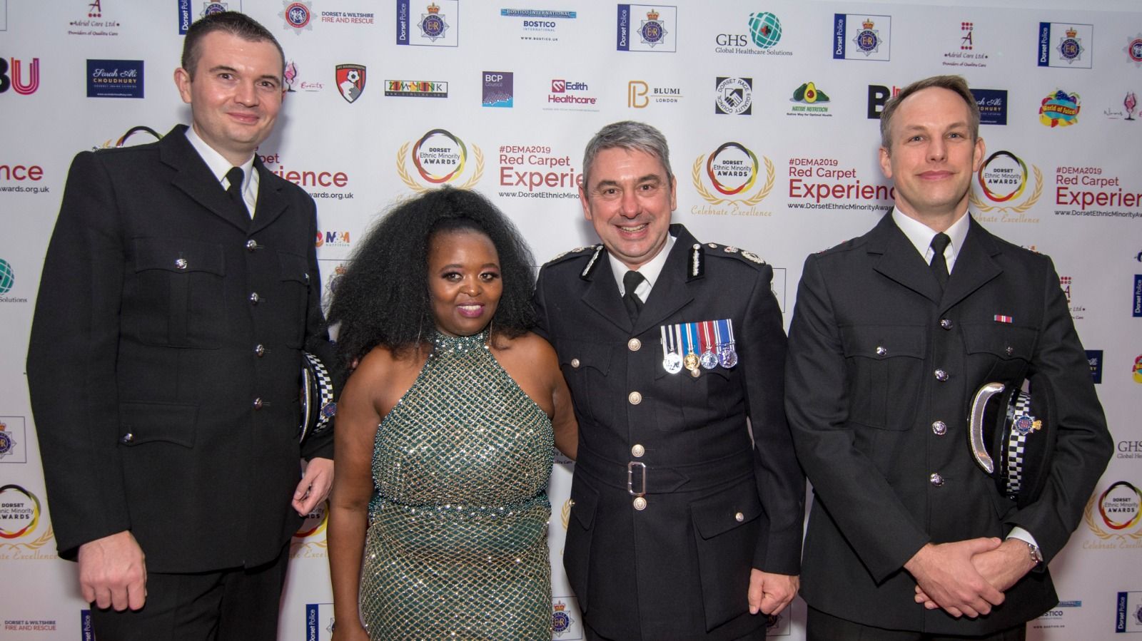 Dorset Police officers in dress uniform with a guest on the red carpet