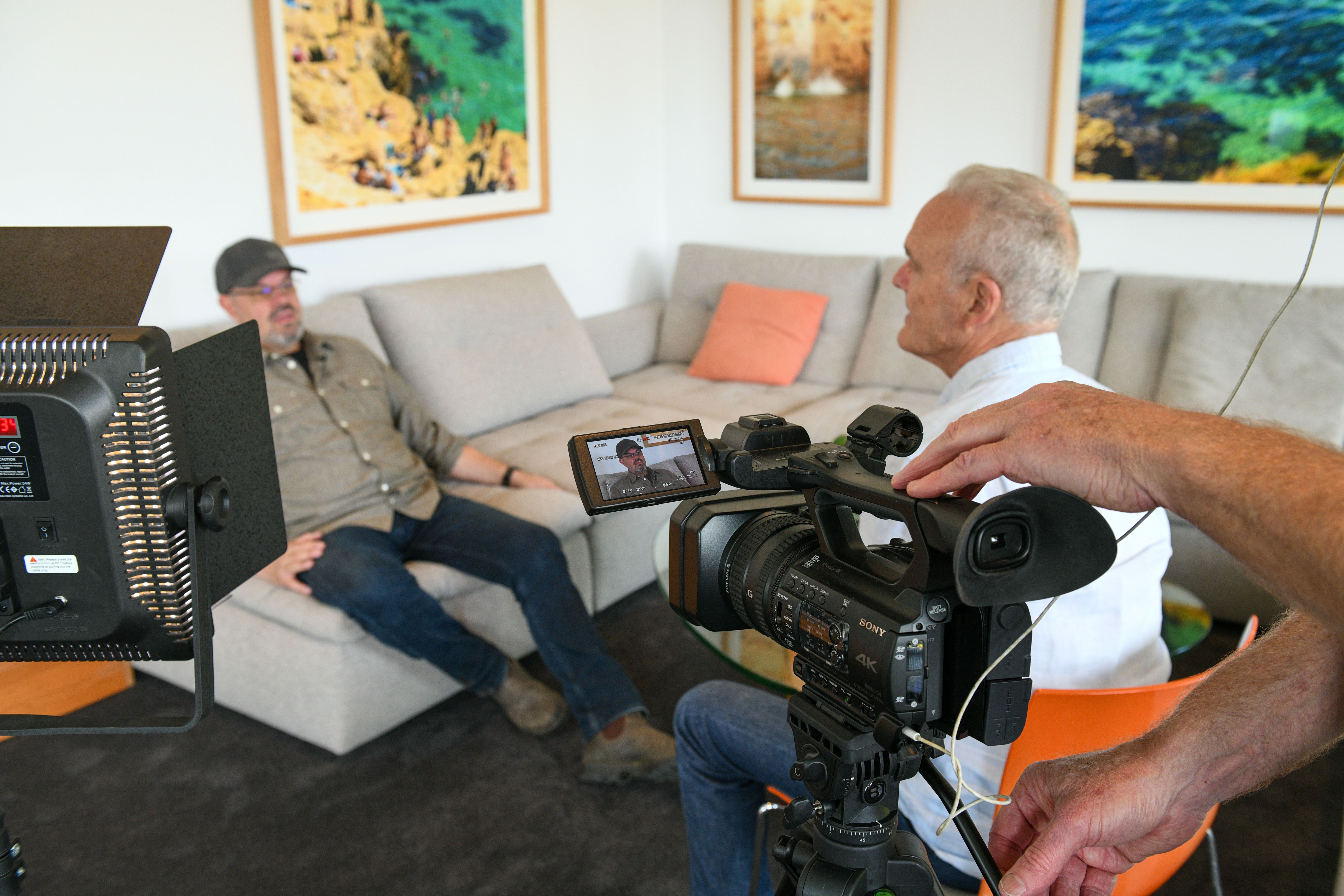 An interviewee smiling during a relaxed conversation at home