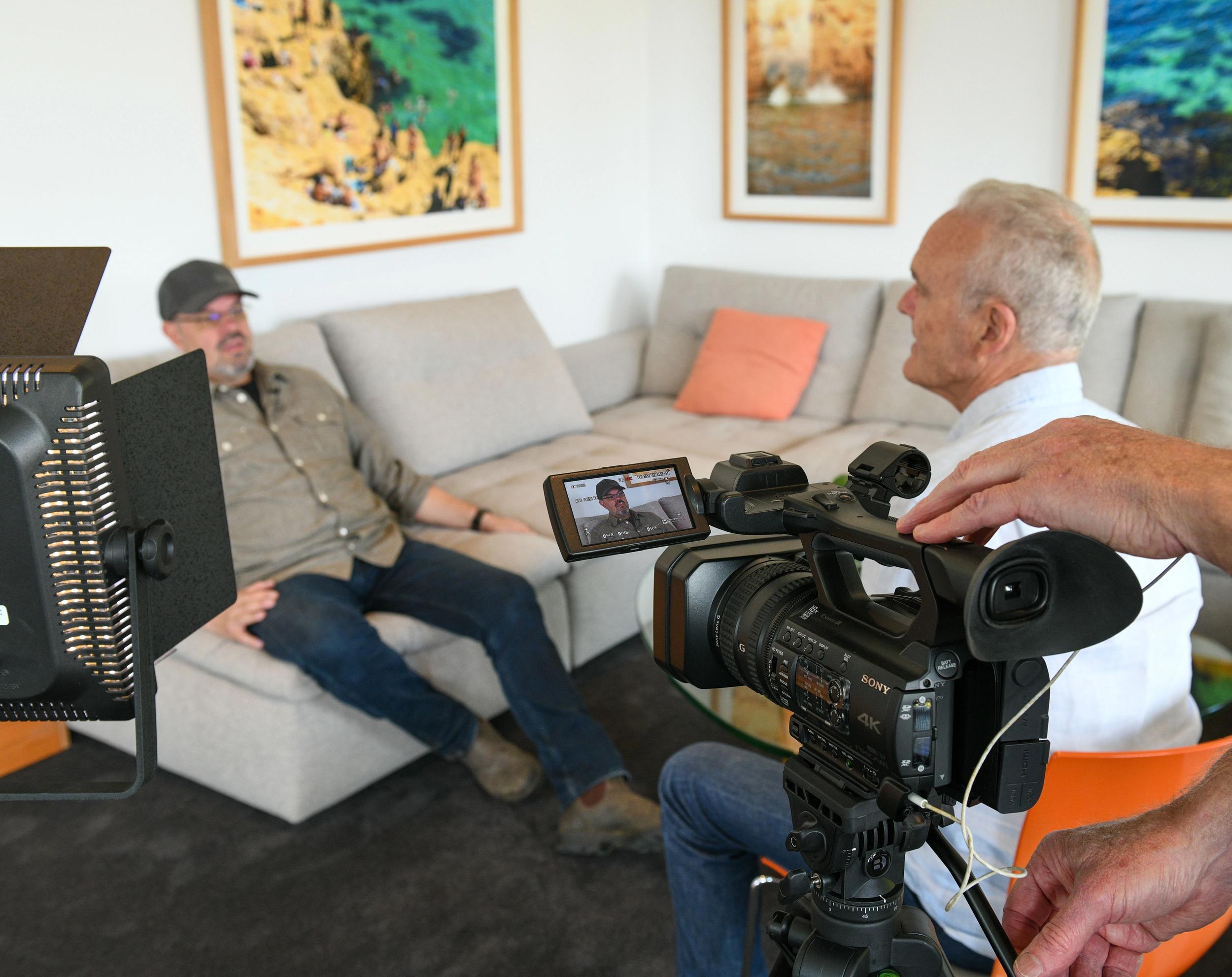 An interviewee smiling during a relaxed conversation at home
