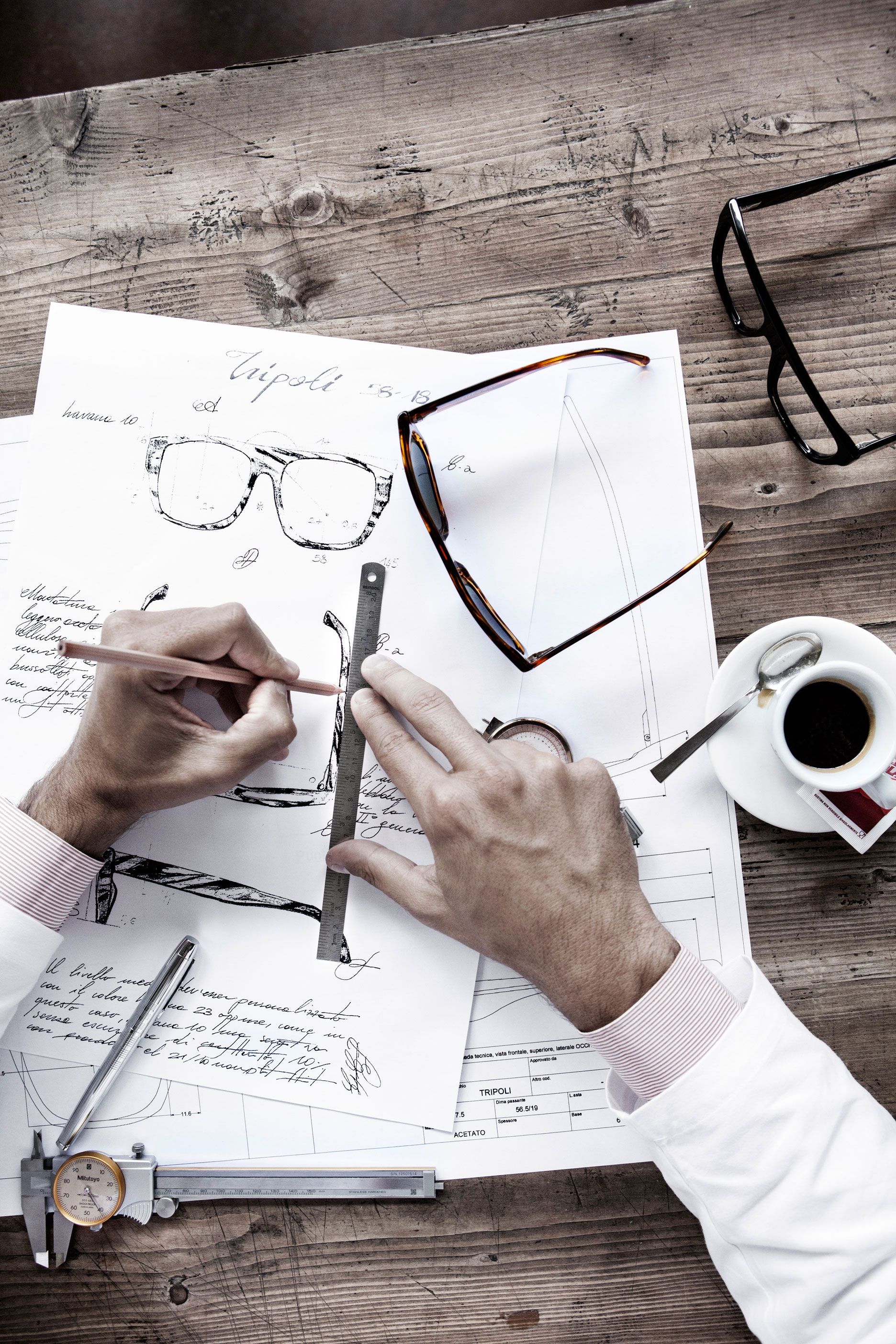 Sunglasses being designed and drawn on paper.
