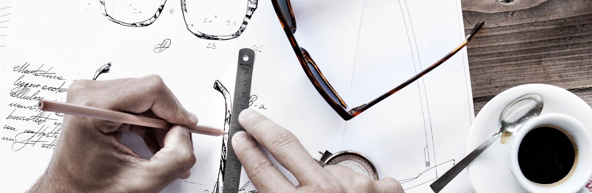 Sunglasses being designed and drawn on paper.