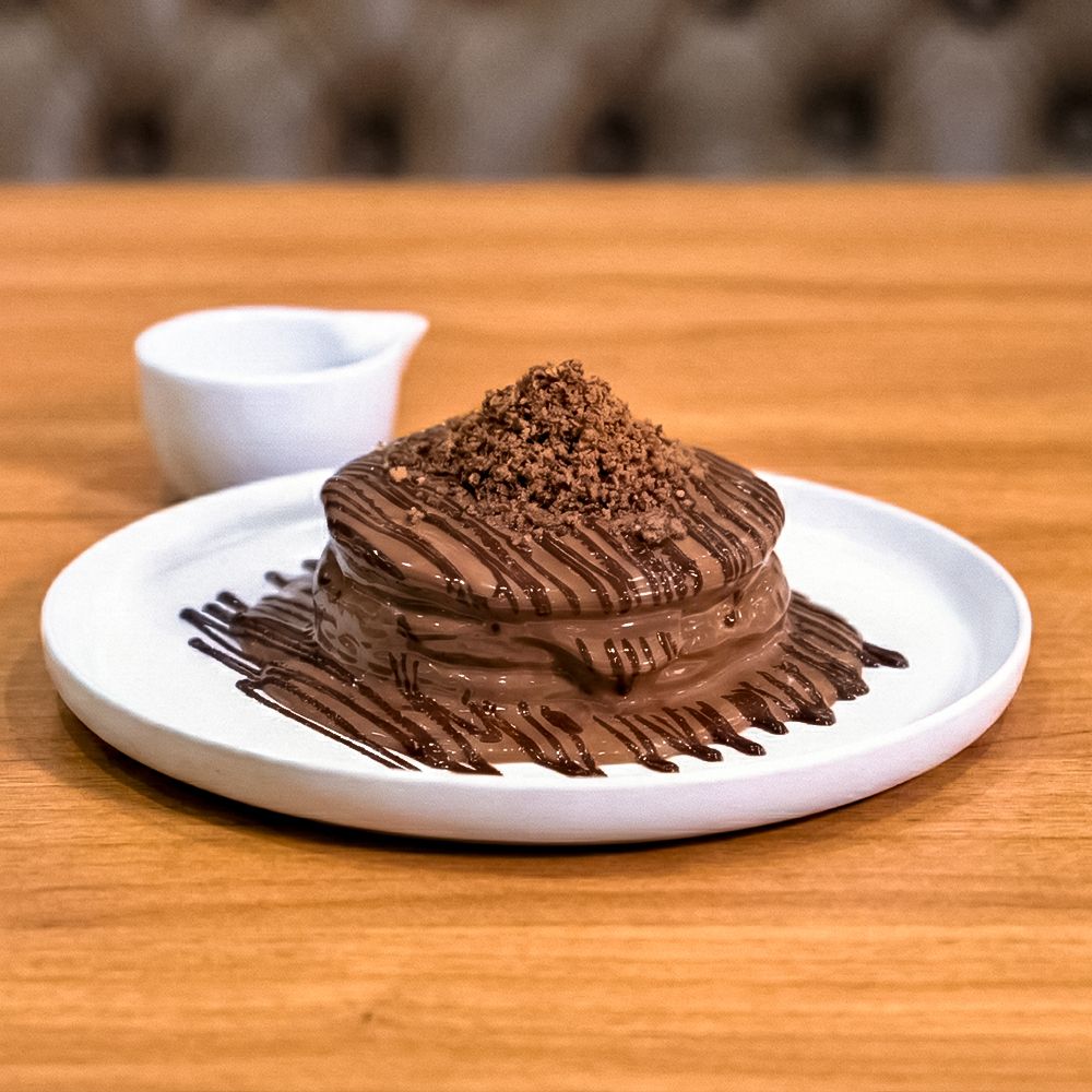 Stack of Fluffy Cookie Pancakes with Milk Chocolate and Cream Cheese Filling at Asador Coffee El Jadida