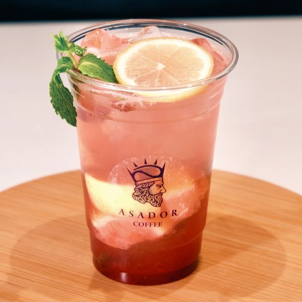 Iced Strawberry Mojito Mocktail with Fresh Mint and Lemon Slice in Plastic Cup at Asador Coffee El Jadida