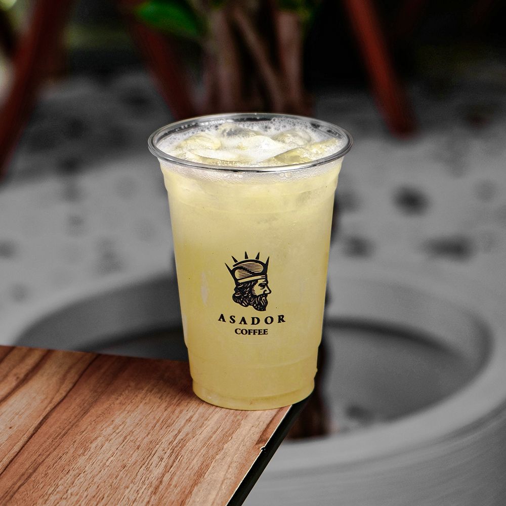 Iced Piña Colada Lemonade with Pineapple and Coconut Flavor in Plastic Cup at Asador Coffee El Jadida