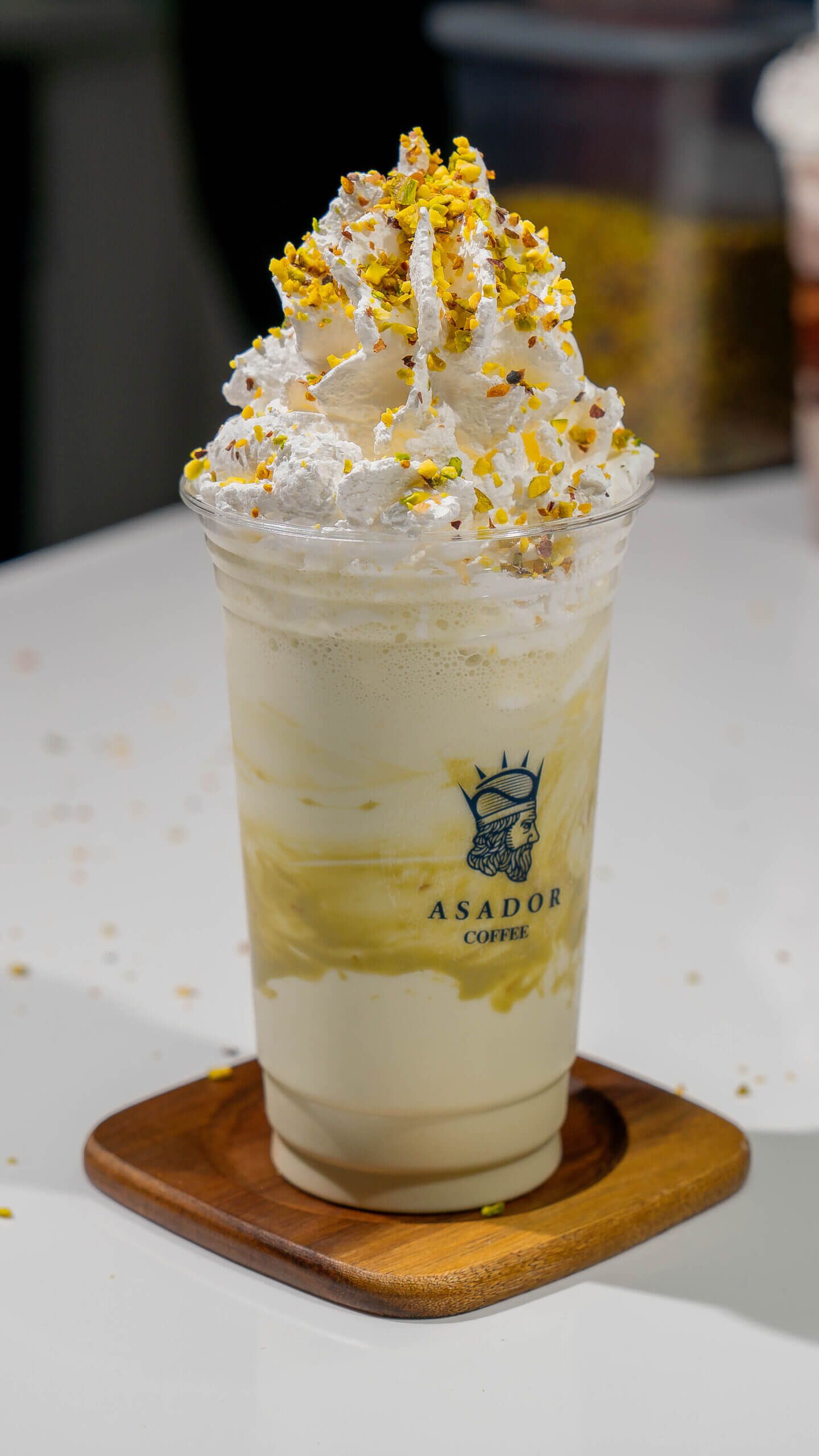 Pistachio Milkshake with Whipped Cream and Crushed Nuts in Plastic Cup at Asador Coffee El Jadida