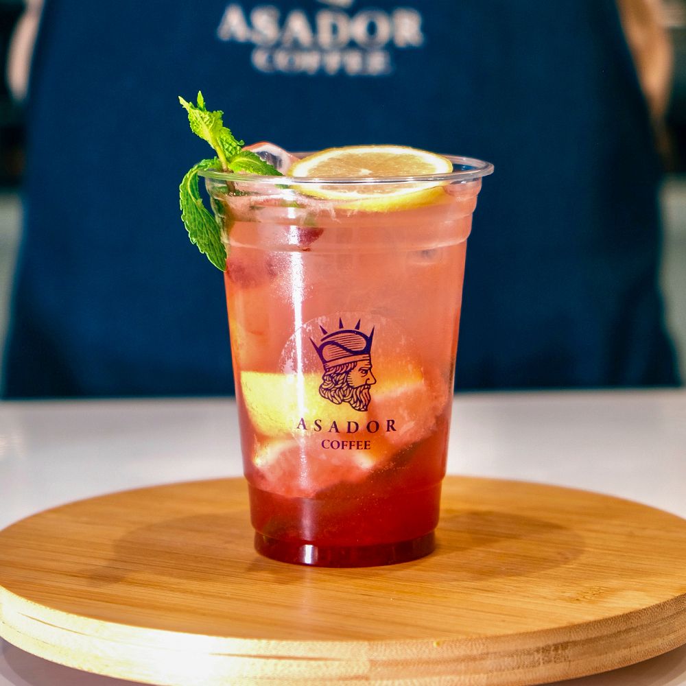 Iced Strawberry Mojito Mocktail with Fresh Mint and Lemon Slice in Plastic Cup at Asador Coffee El Jadida