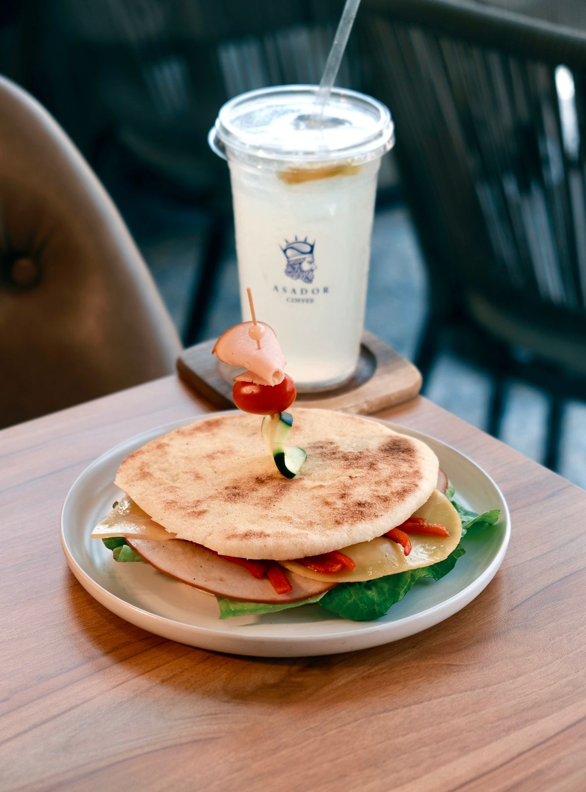 Toasted Power Loaf Sandwich with Smoked Turkey and Peppers on Wooden Plate at Asador Coffee El Jadida