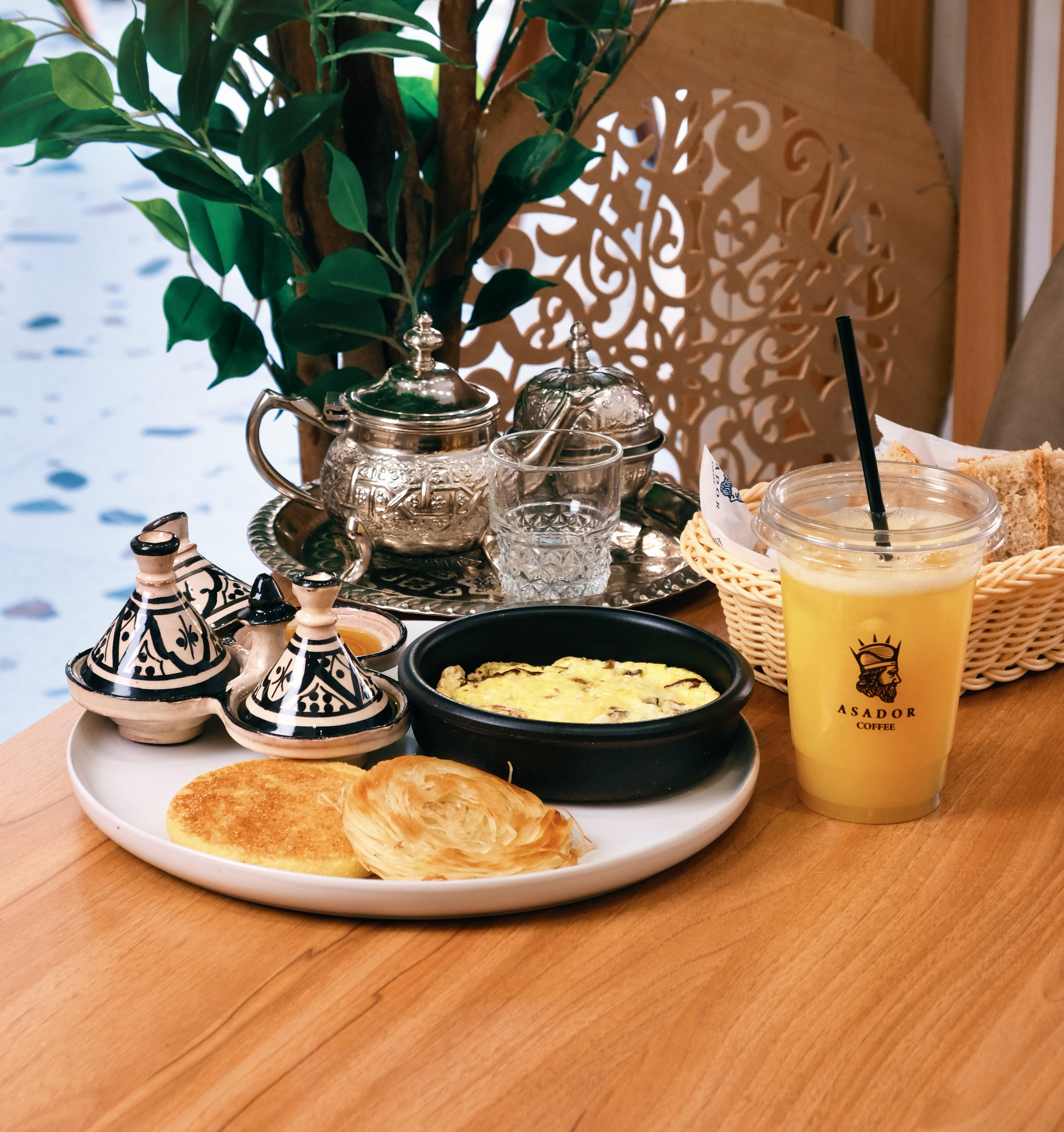 Traditional Moroccan Breakfast with Eggs Msemen Harcha Mint Tea and Orange Juice at Asador Coffee El Jadida