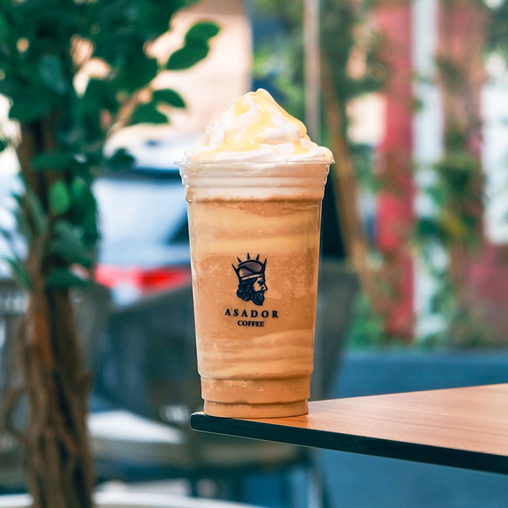 Iced White Mocha Frappe with Whipped Cream Topping in Plastic Cup at Asador Coffee El Jadida