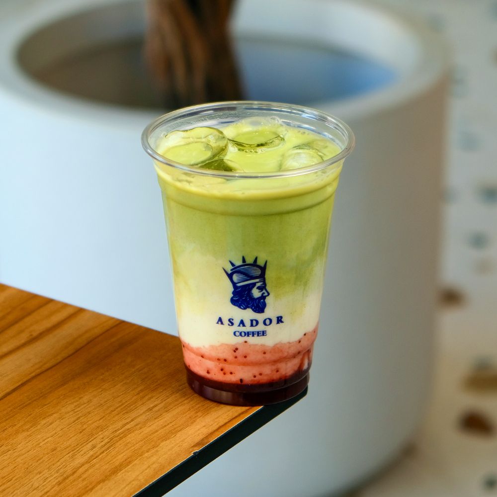Iced Strawberry Matcha Latte with Pink and Green Layers in Plastic Cup at Asador Coffee El Jadida