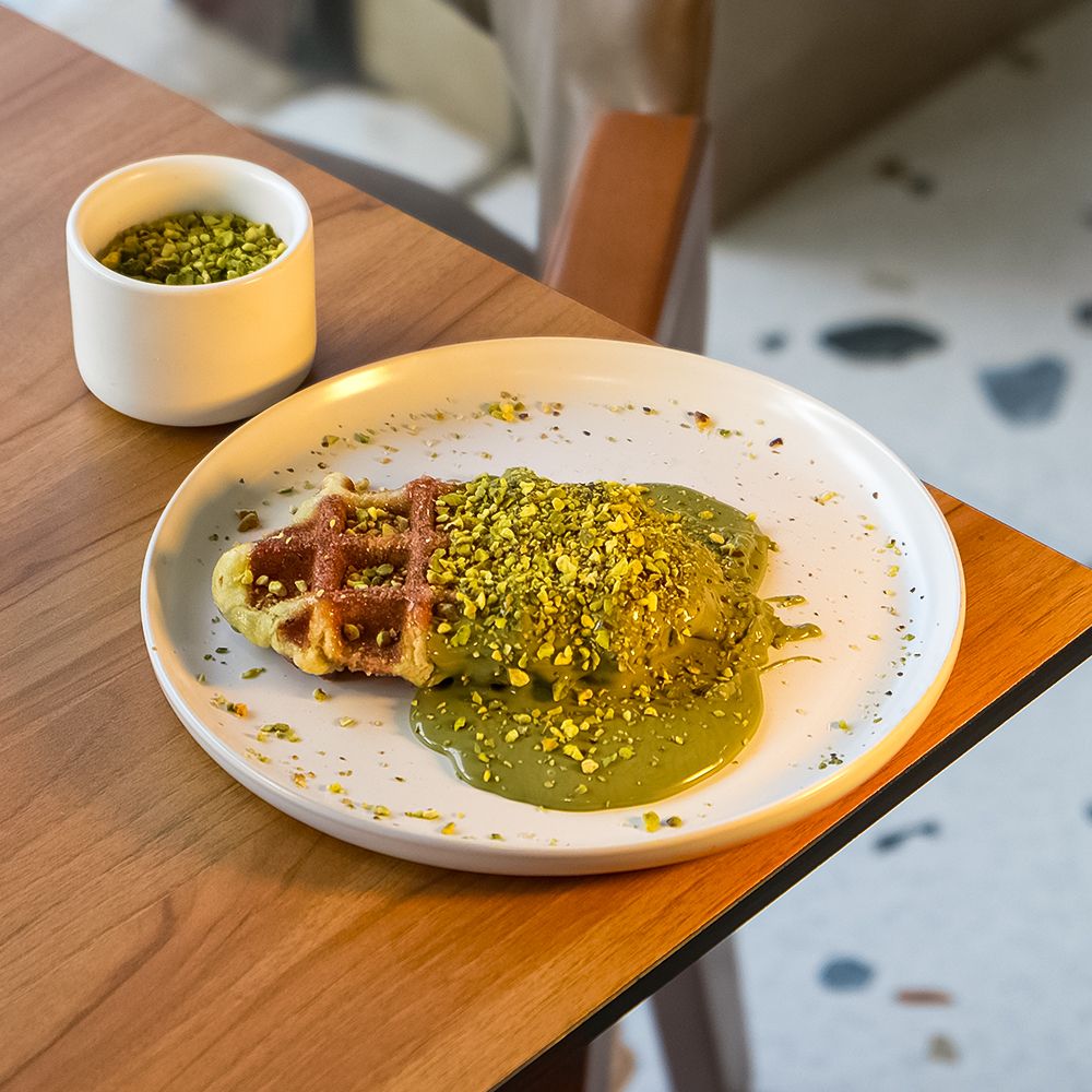 Freshly Baked Pistachio Waffle with Rich Green Nut Cream and Crushed Pistachios at Asador Coffee El Jadida