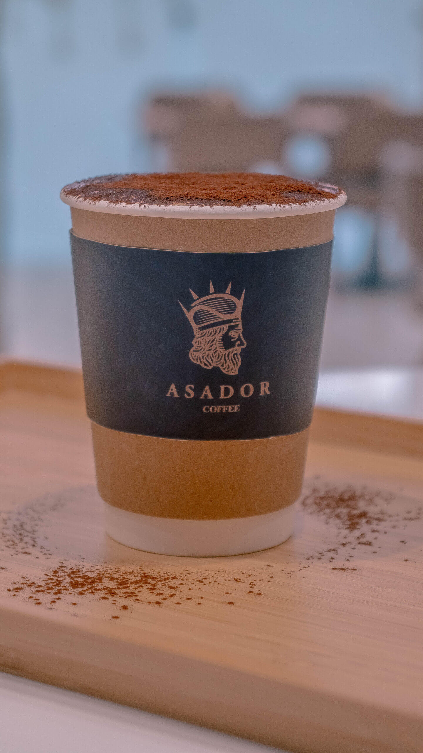 Classic Cappuccino with Cocoa Powder Dusting on Wooden Board at Asador Coffee El Jadida
