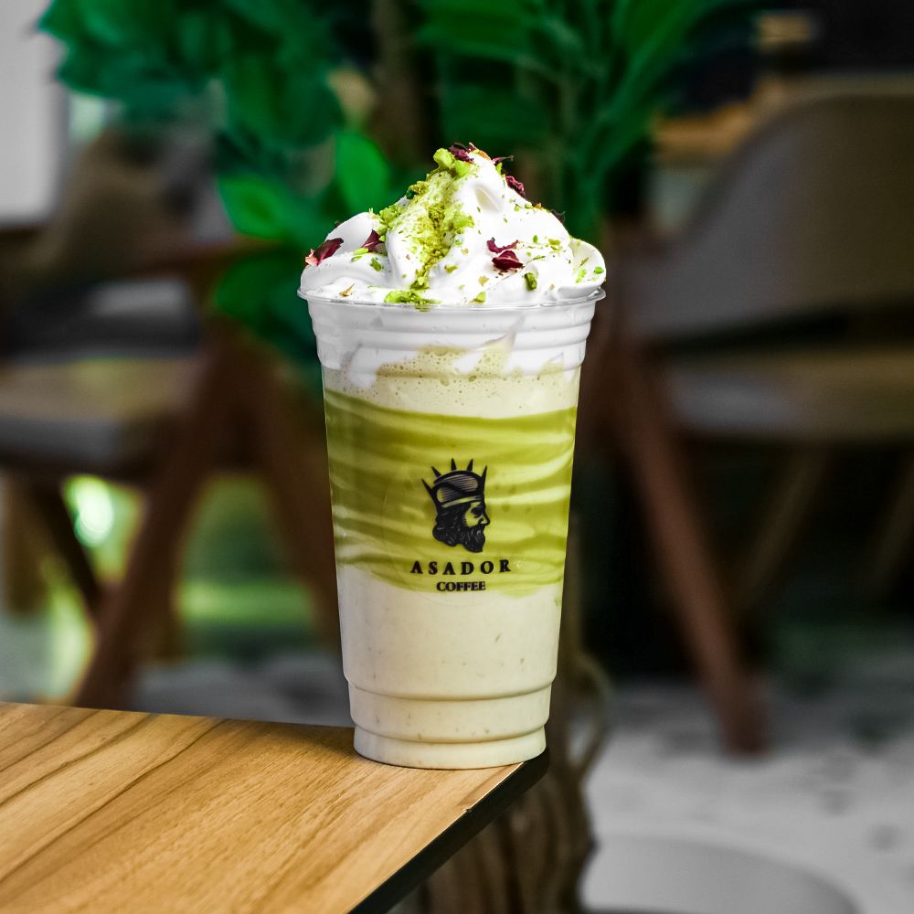 Pistachio Milkshake with Whipped Cream and Crushed Nuts in Plastic Cup at Asador Coffee El Jadida