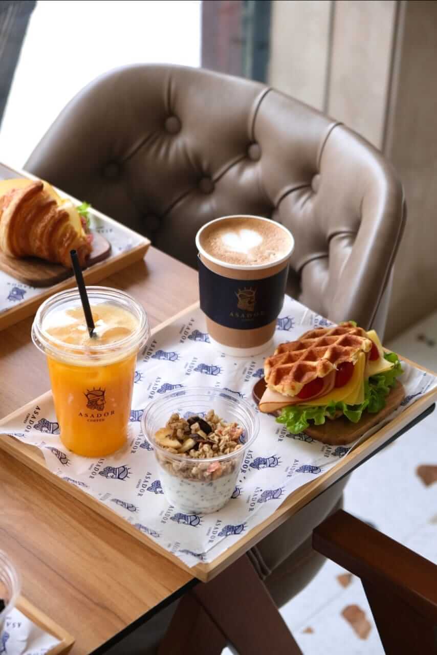 Full Breakfast Tray with Savory Smoked Turkey Waffle, Granola Yogurt, and Orange Juice at Asador Coffee El Jadida