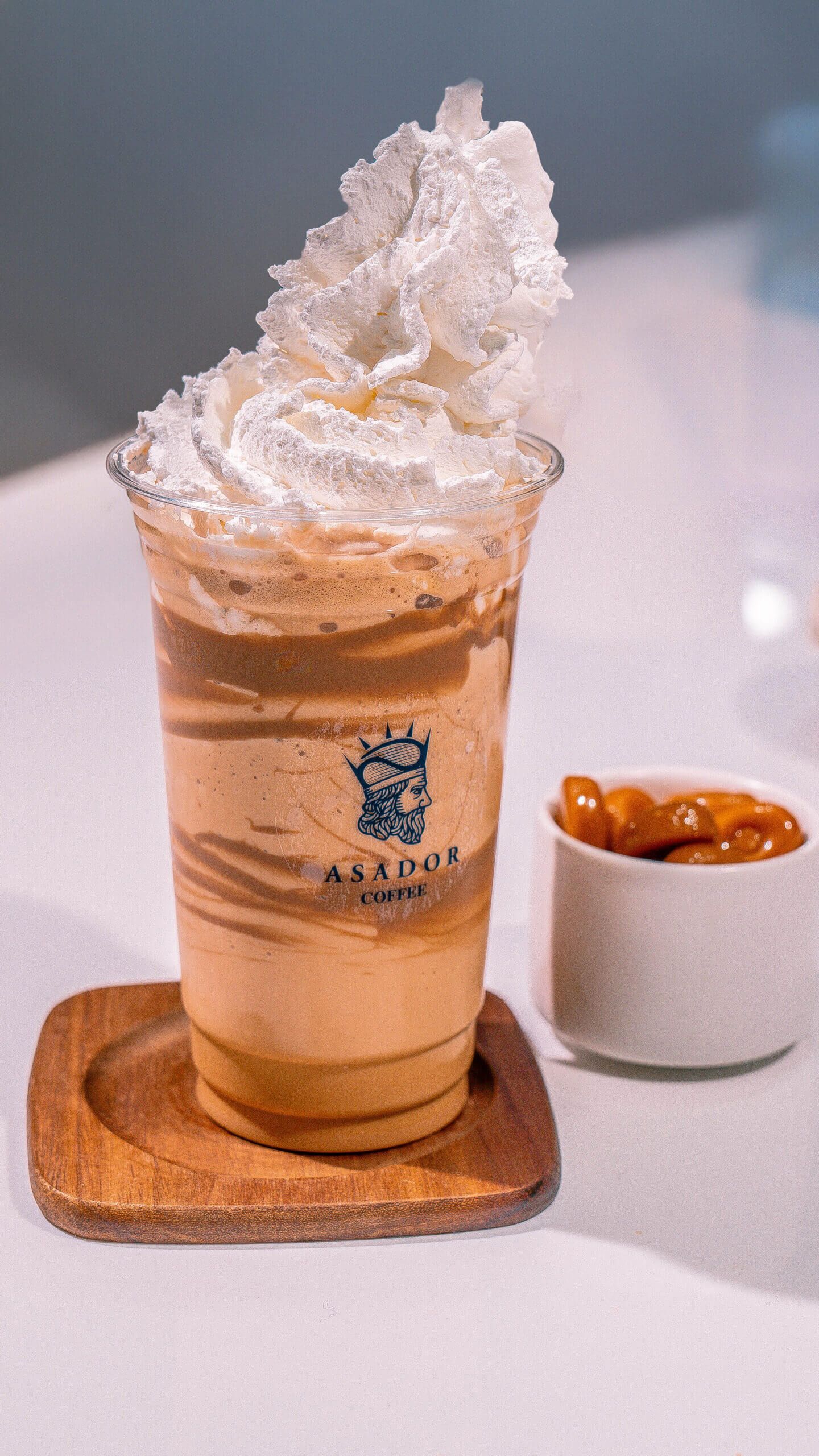 Iced Salted Caramel Frappe with Whipped Cream Topping in Plastic Cup at Asador Coffee El Jadida