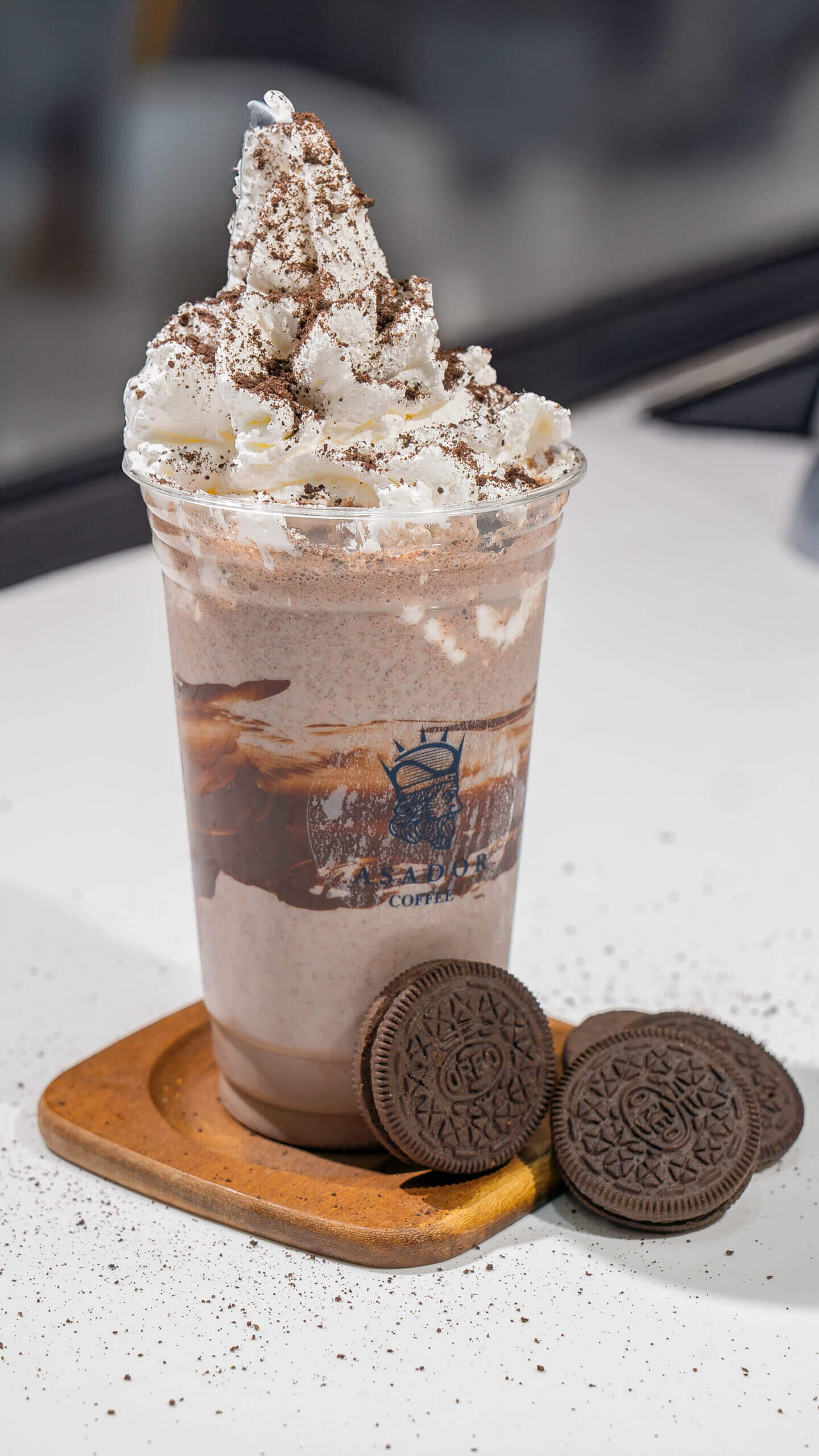 Thick Oreo Milkshake with Whipped Cream and Cookie Garnish in Plastic Cup at Asador Coffee El Jadida