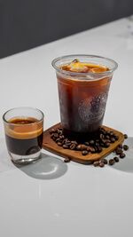 Iced Americano Black Coffee with Espresso Shot Glass and Coffee Beans at Asador Coffee El Jadida