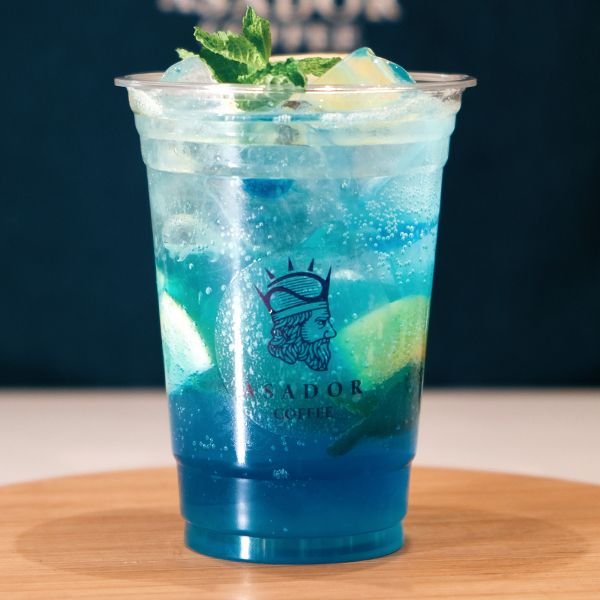 Iced Blue Curacao Mocktail with Lemon and Mint in Plastic Cup at Asador Coffee El Jadida