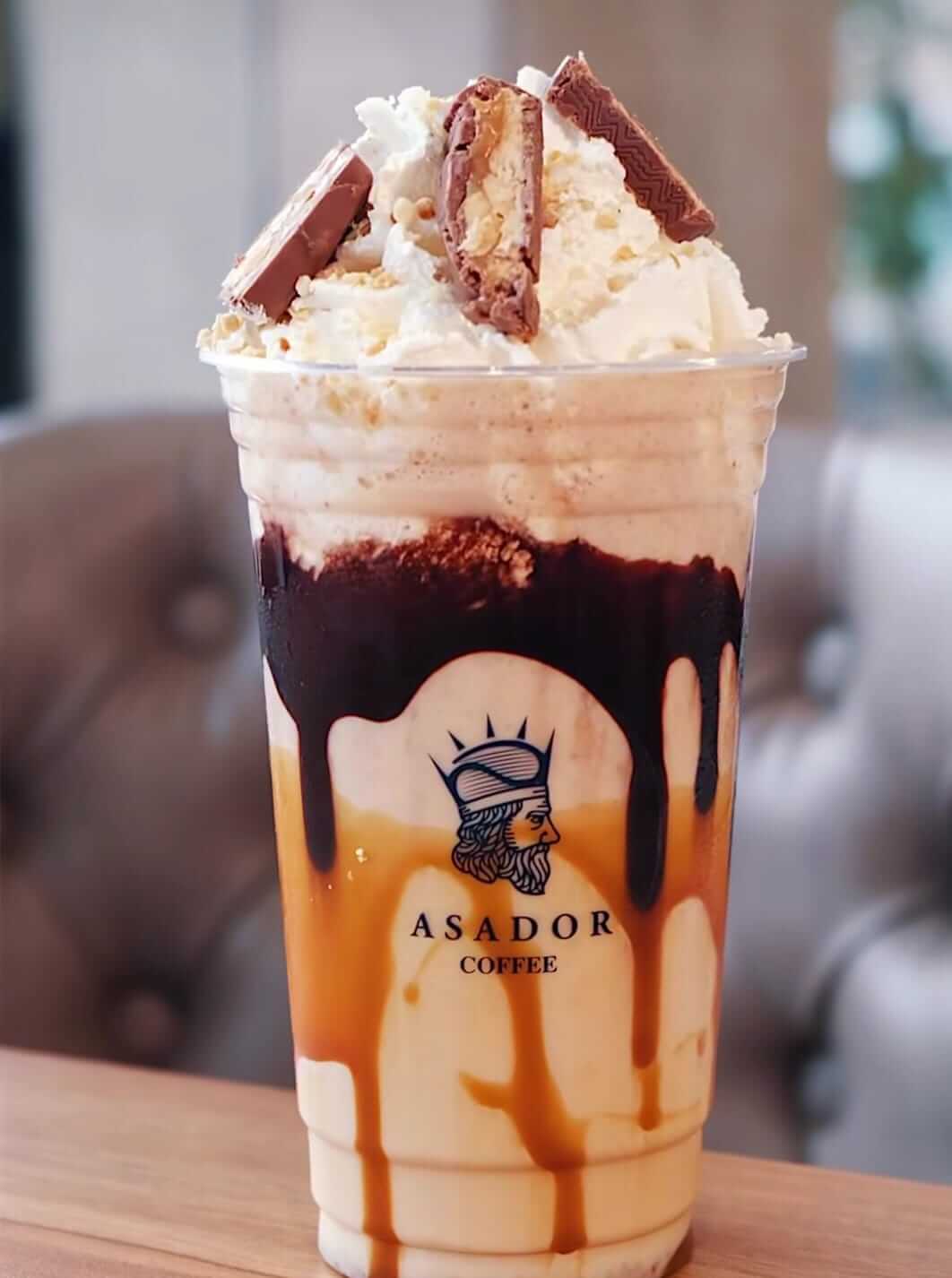 Snickers Milkshake with Peanut Butter and Chocolate Sauce in Plastic Cup at Asador Coffee El Jadida