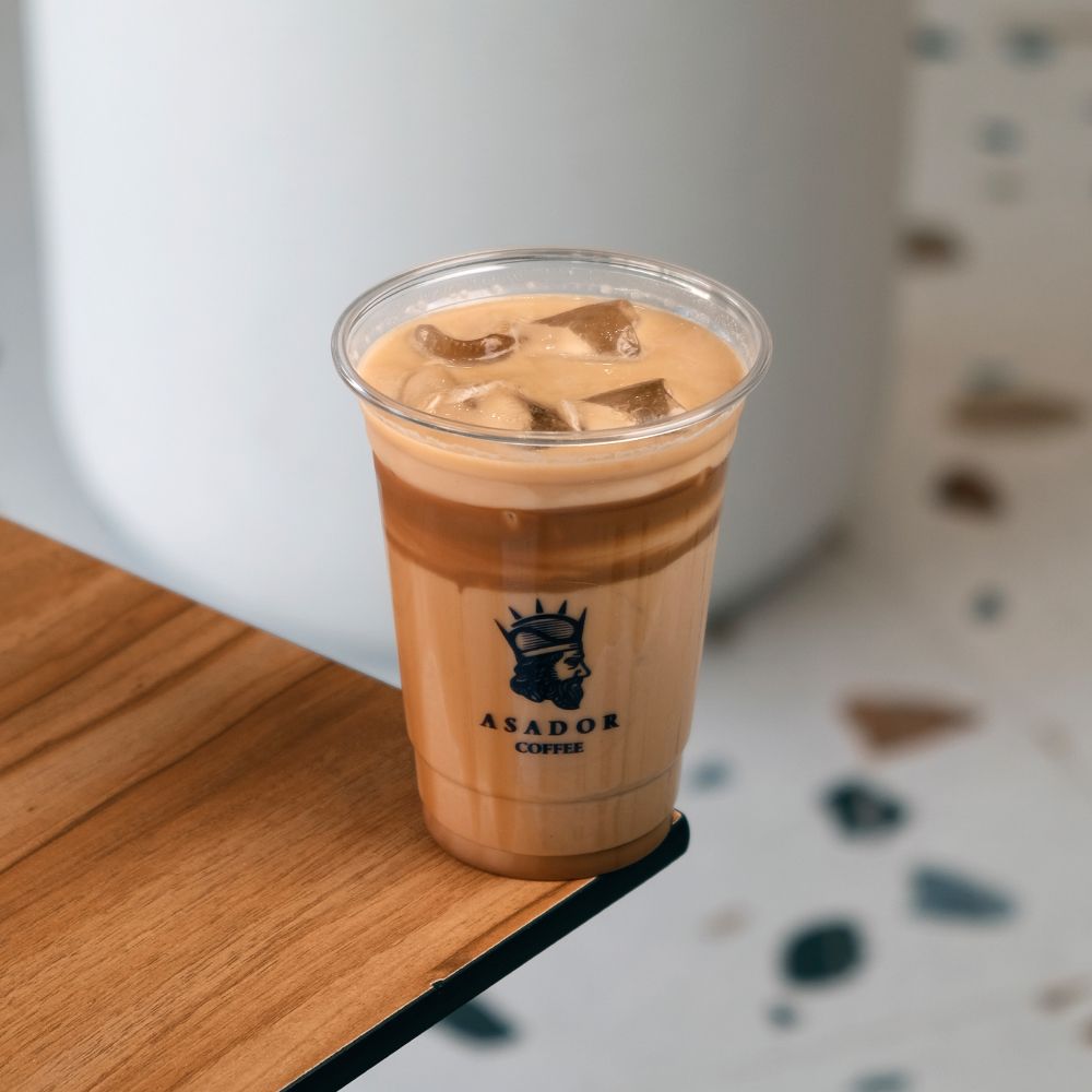 Iced Gold Cappuccino with Caramel and Cold Foam in Plastic Cup at Asador Coffee El Jadida