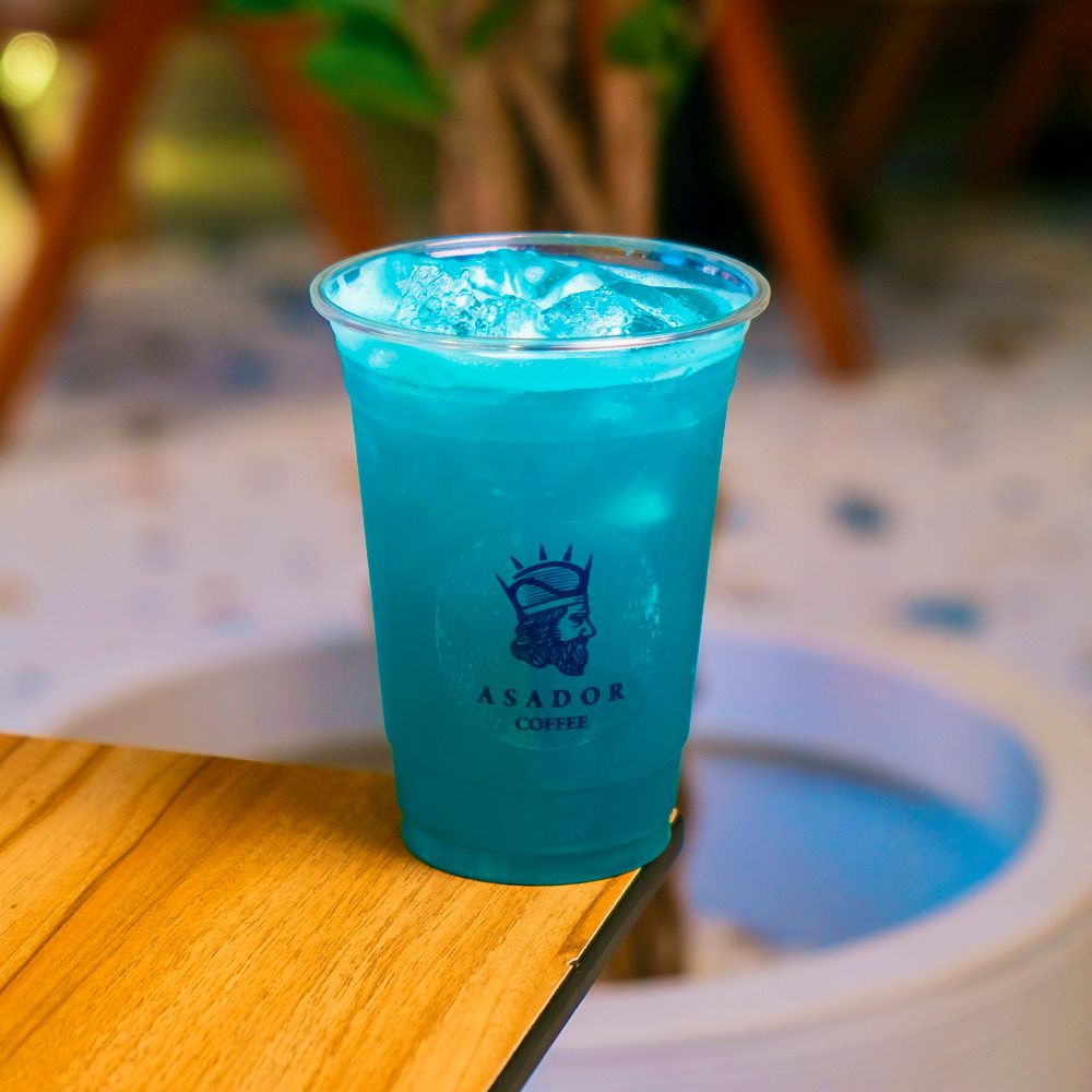 Iced Blue Ocean Lemonade with Green Apple Slices in Plastic Cup at Asador Coffee El Jadida