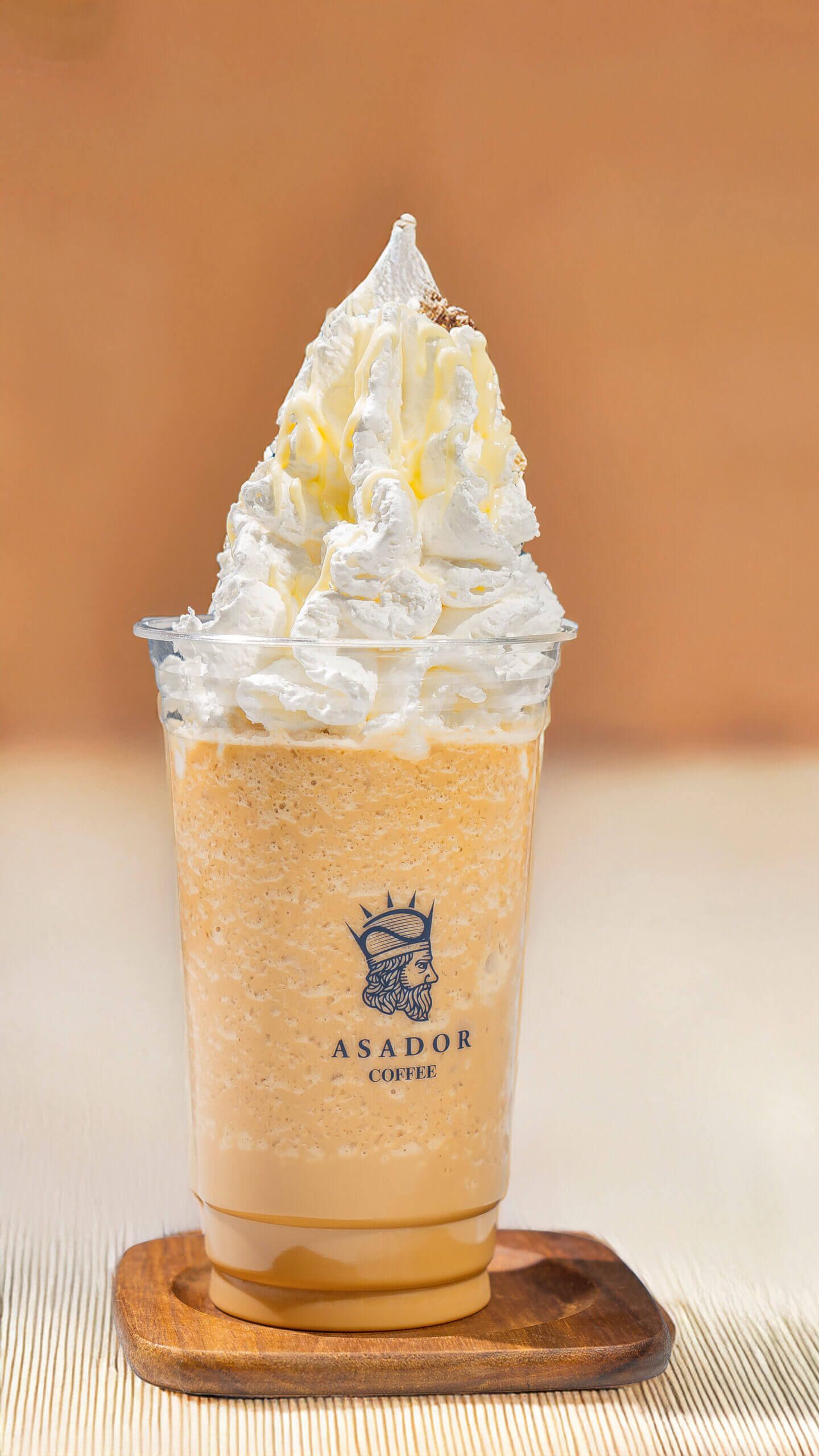 Iced White Mocha Frappe with Whipped Cream Topping in Plastic Cup at Asador Coffee El Jadida